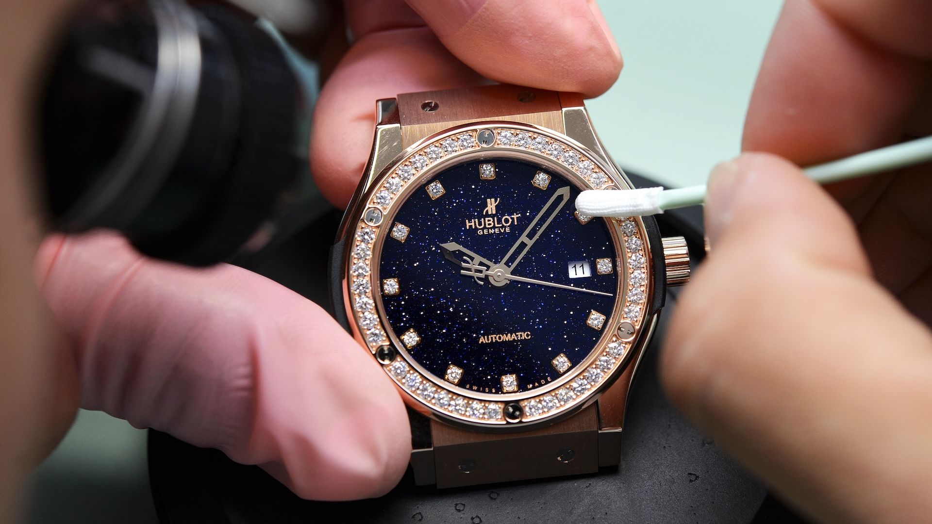TO GO WITH AFP STORY IN FRENCH BY AGNES PEDRERO OSTERTAGAn employee of Swiss watchmaker Hublot works on a watch intended for the Chinese market, on October 23, 2012, in Paudex, western Switzerland. Success-driven Chinese people love Swiss watches and have today become a driving force behind the Swiss watch market. However, Swiss watchmakers are asking themselves: should they make more Chinese themed special edition models to conquer this market or should they wait for the tastes of Chinese customers to adapt to European fashion ? AFP PHOTO / FABRICE COFFRINI (Photo credit should read FABRICE COFFRINI/AFP via Getty Images)