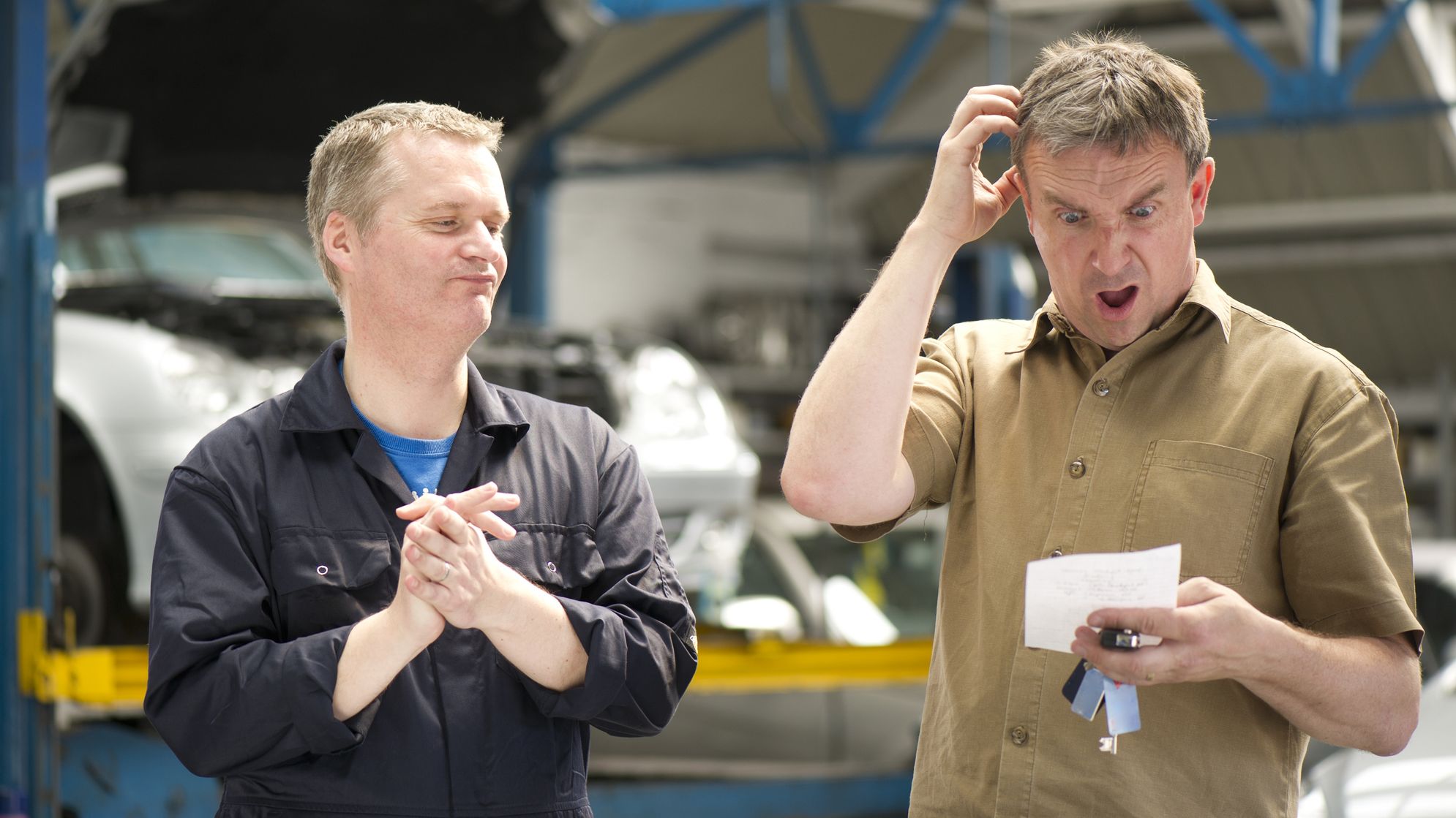 a man receiving a surprise auto repair bill