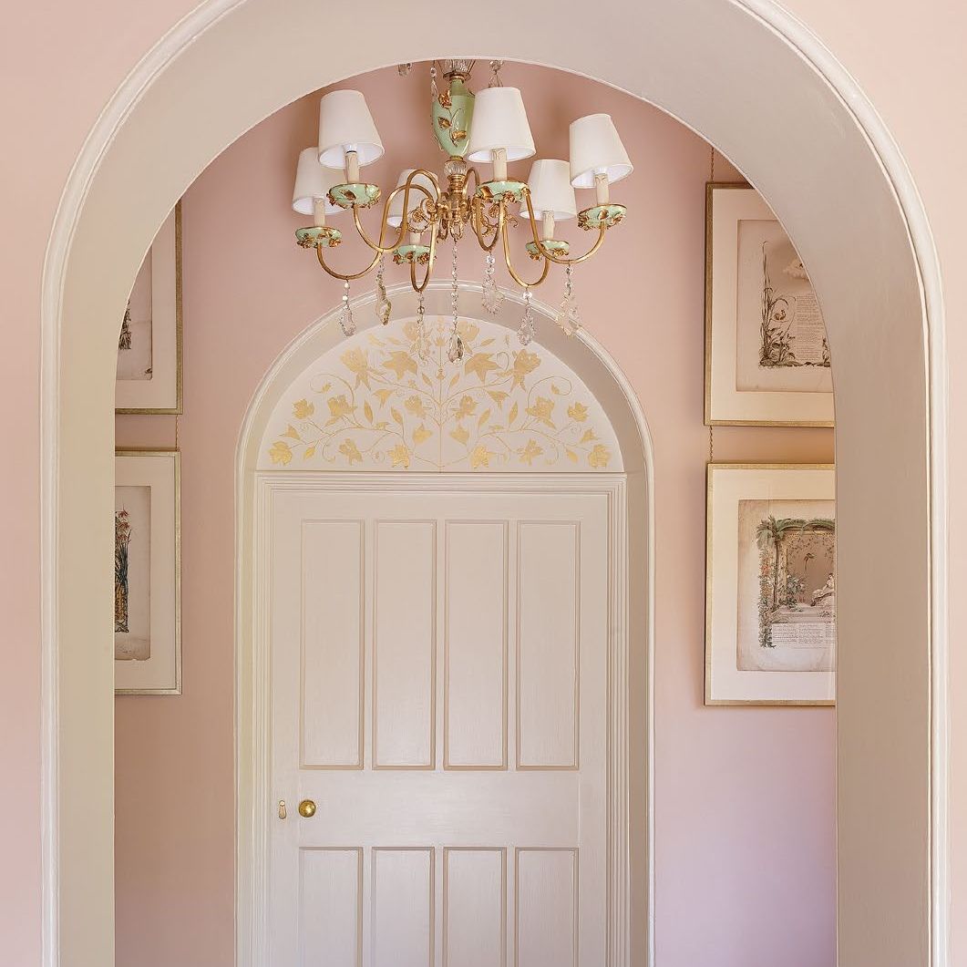 Period hallway with arches painted in pale pink
