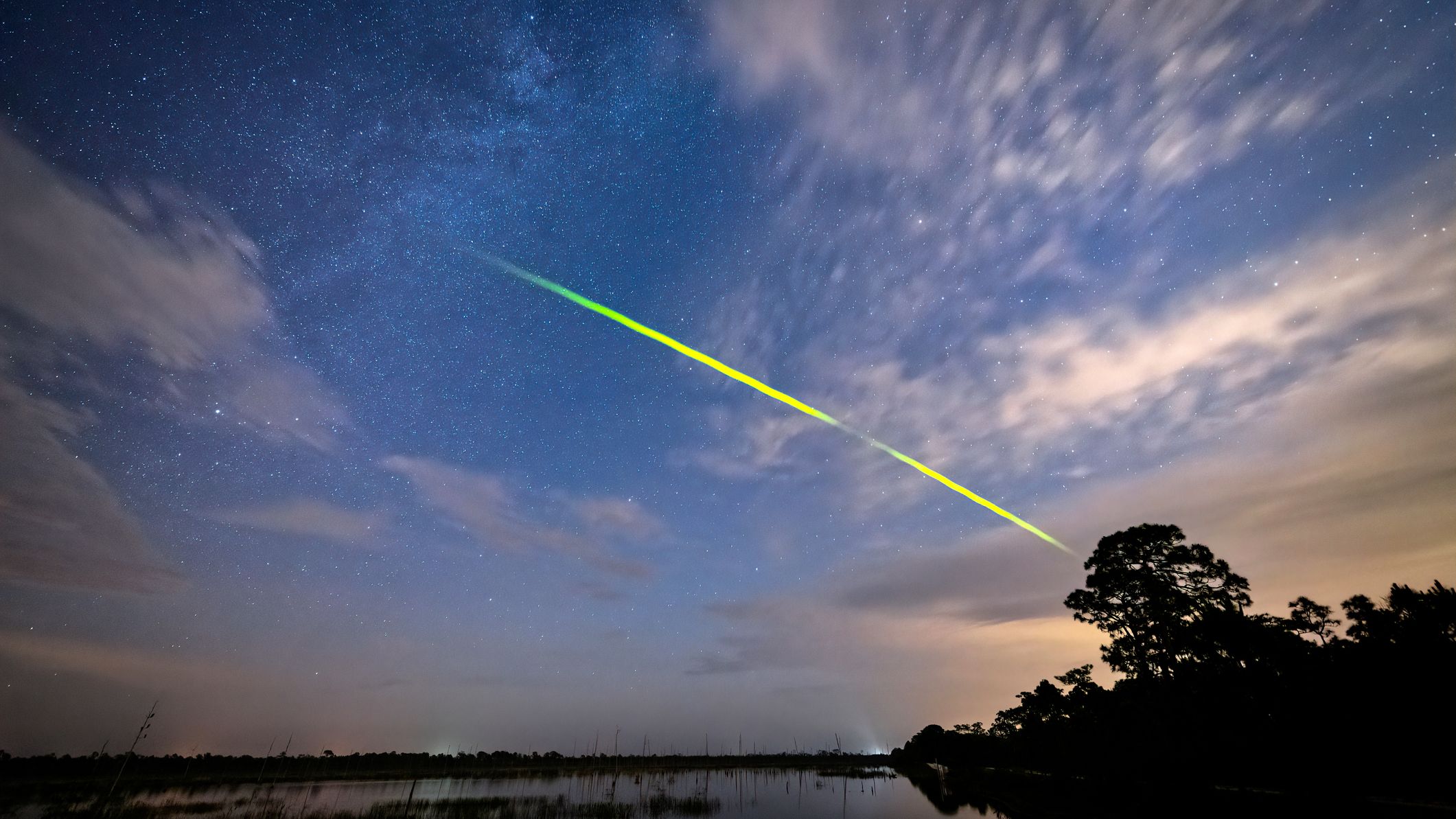 bright green streak of light through the sky.
