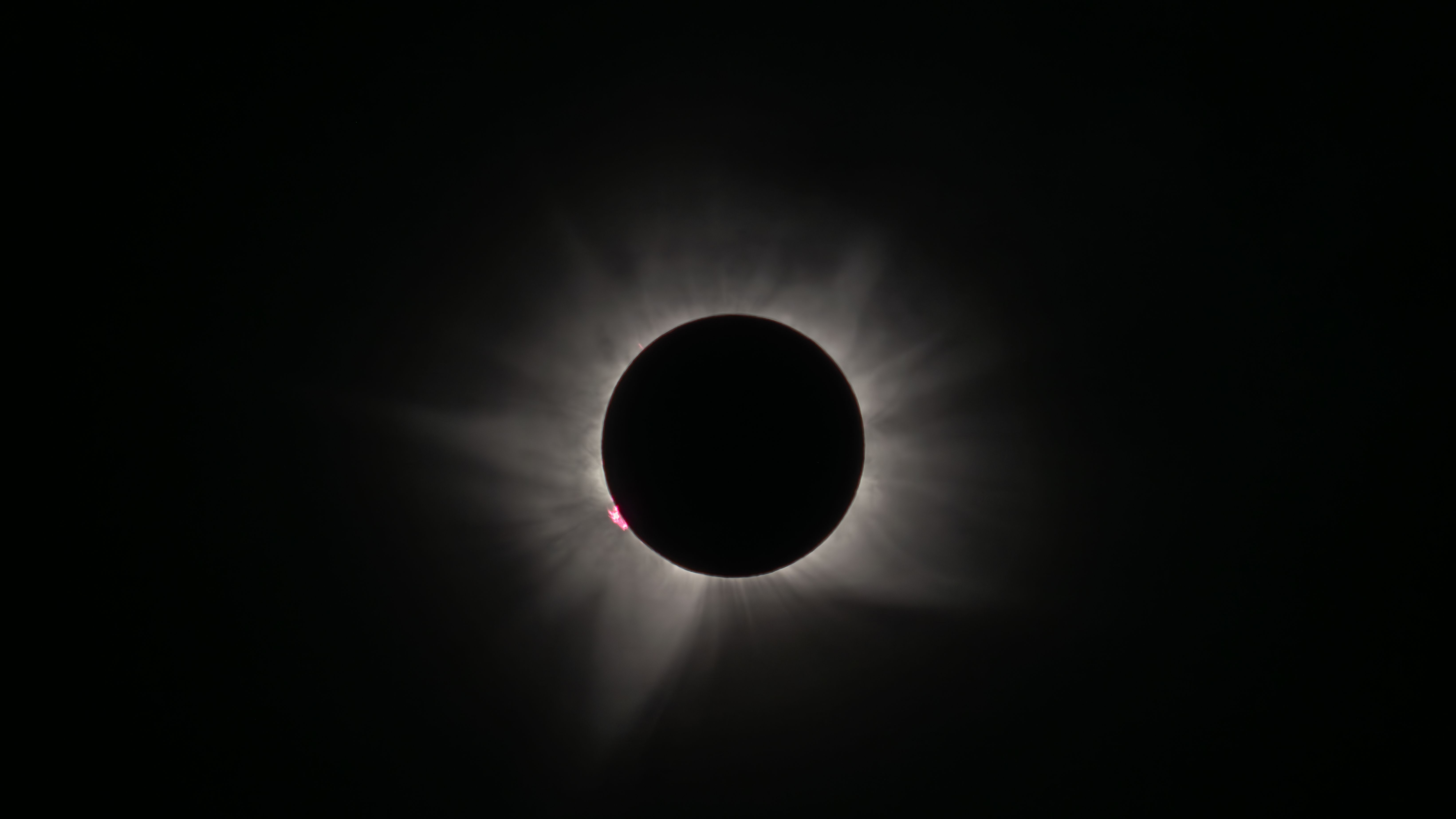 I sailed to Greenland for a total solar eclipse — what I saw left me speechless 8 MyCelestialApp totality - the total solar eclipse with a delicate white halo - the corona and a bright pink prominence in the lower left corner.