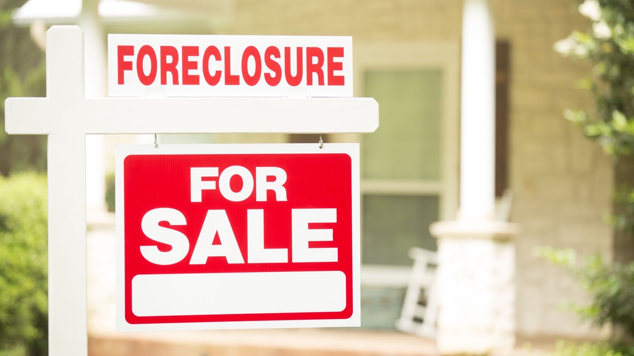 Foreclosure, house for sale sign. Front yard of home.