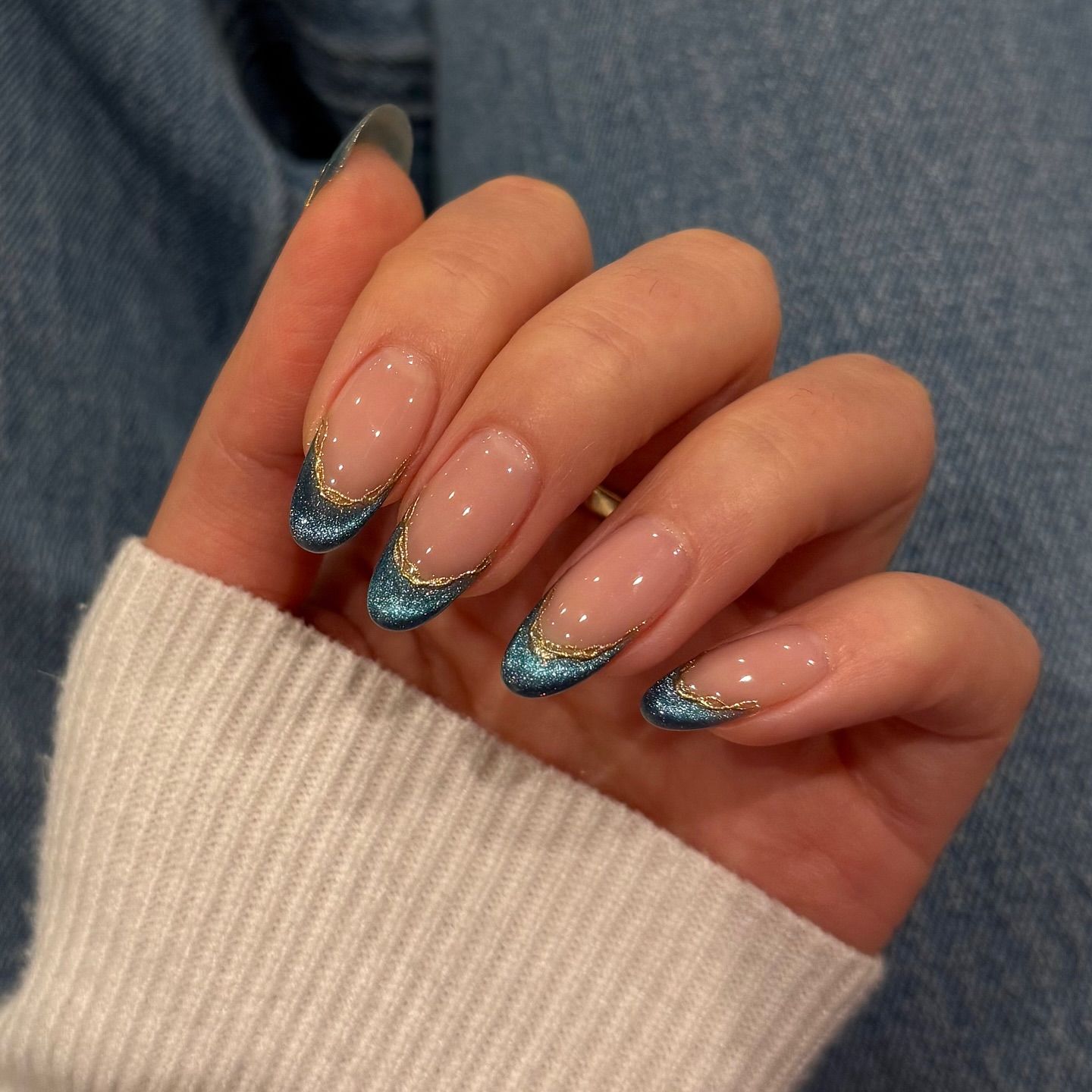 blue manicure with a cat eye french tip