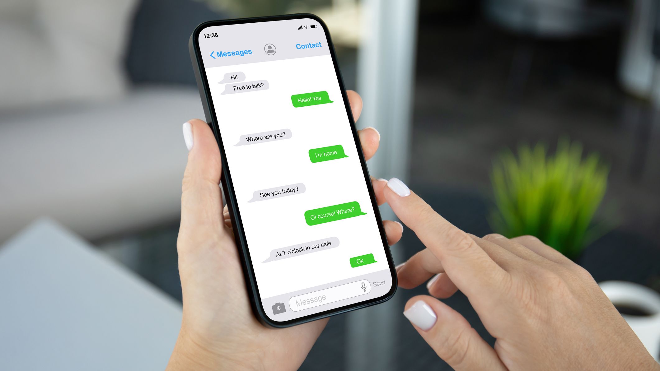 Womans hand hold phone with app messenger on the screen
