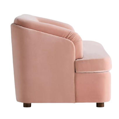 Pink velvet sofa taken from a side angle with dark wood legs on white background