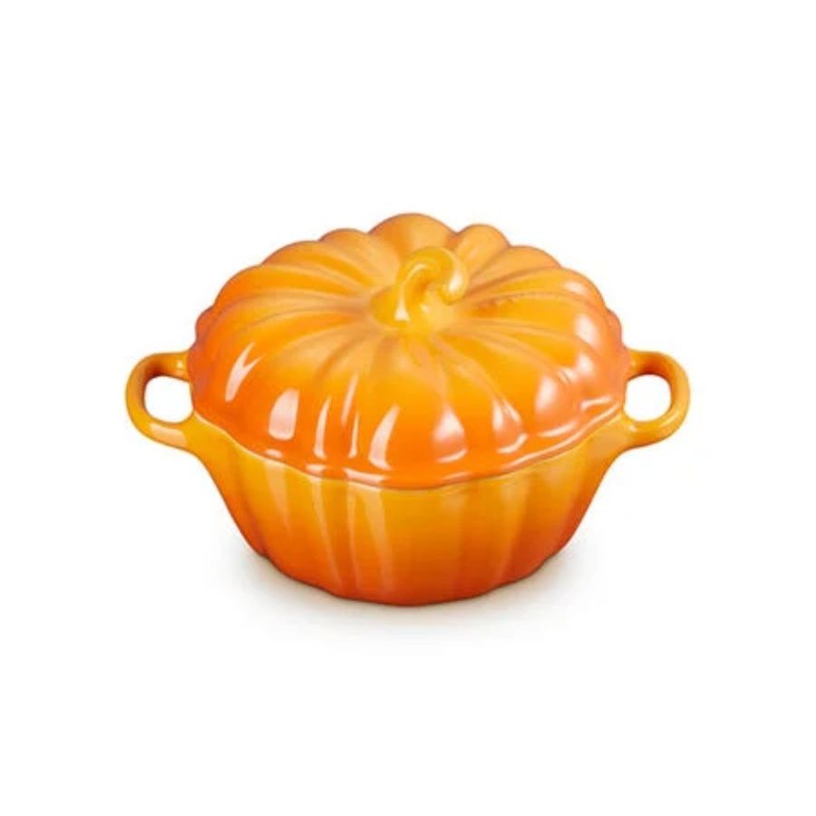A small bright orange Le Creuset pumpkin cocotte