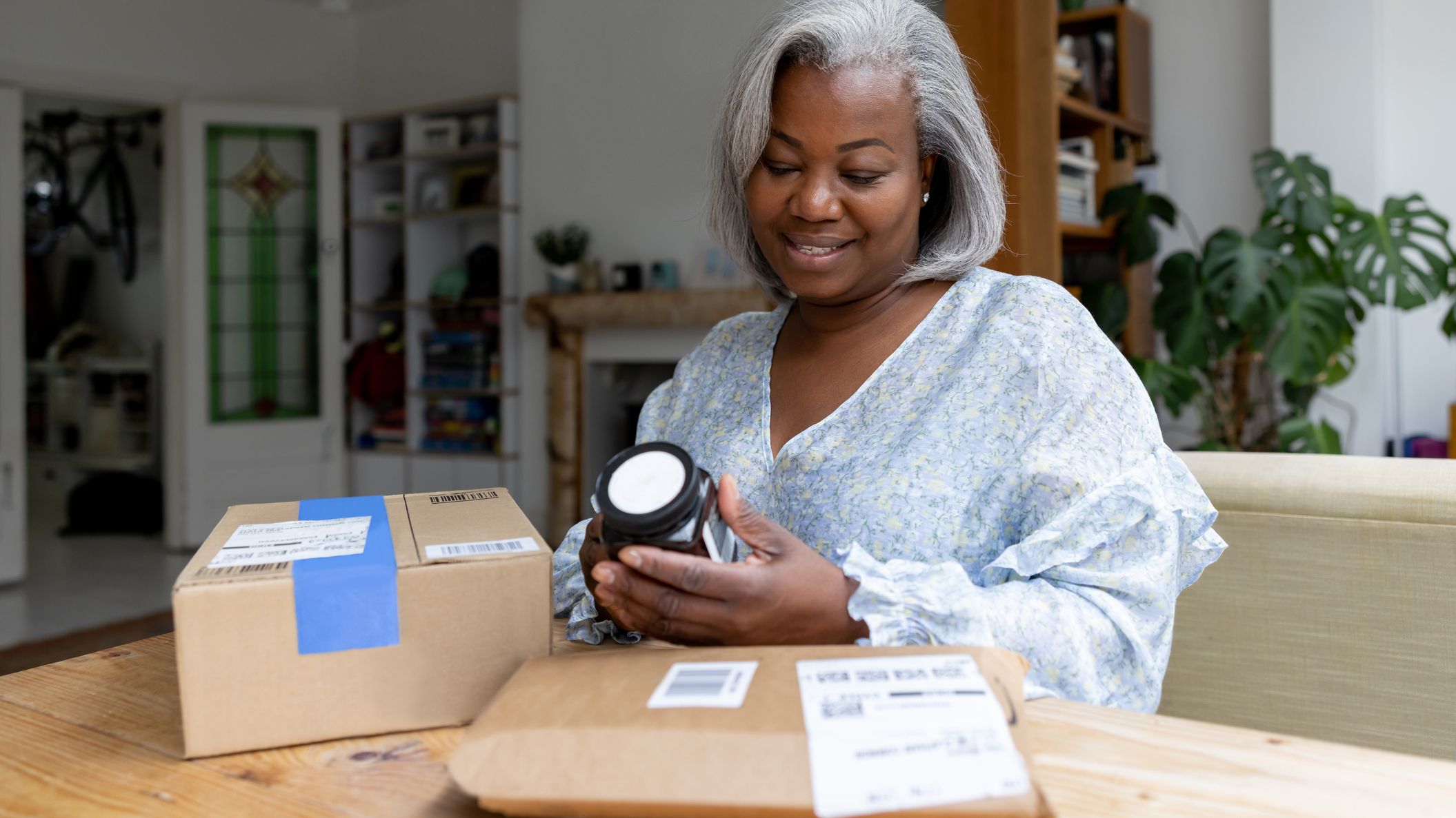 A woman opening a package she received.