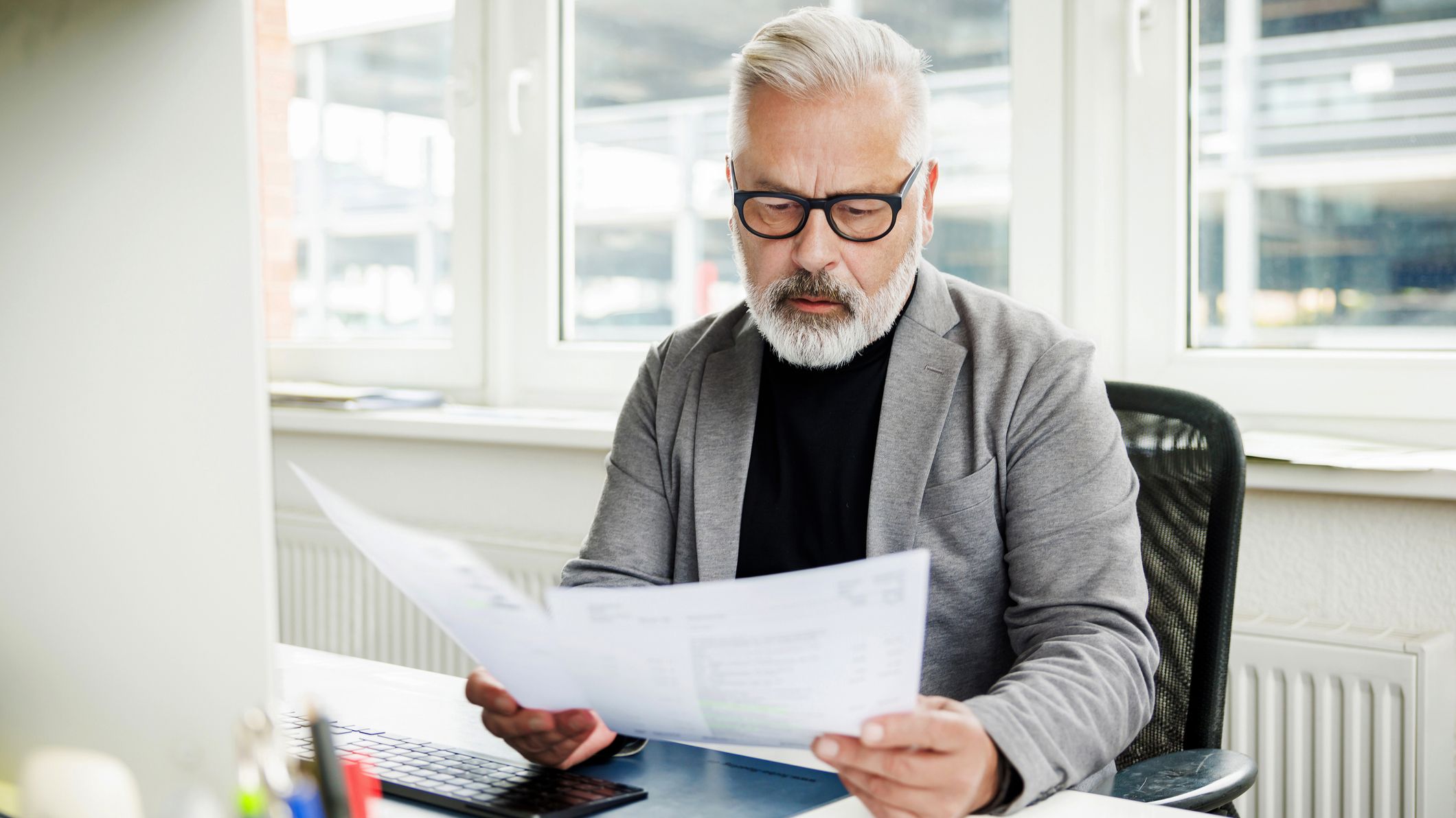 A man reviewing financial documents at desk