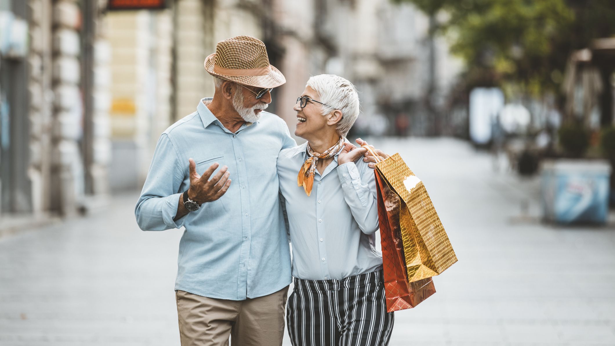 Man and his Beautiful Wife on the City Streets with Paper Bags