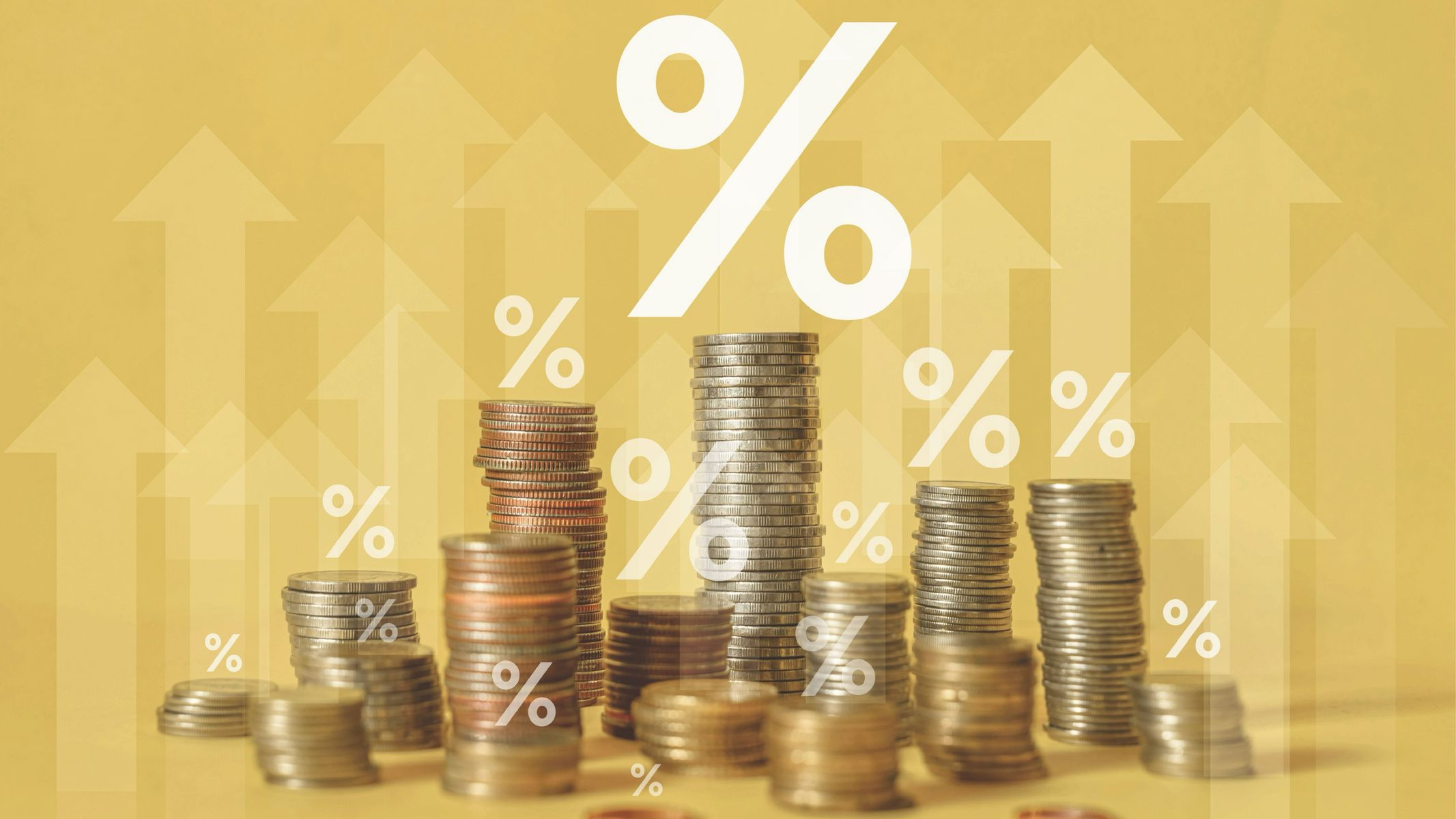Stacks of coins with arrows and percentage signs floating above them.