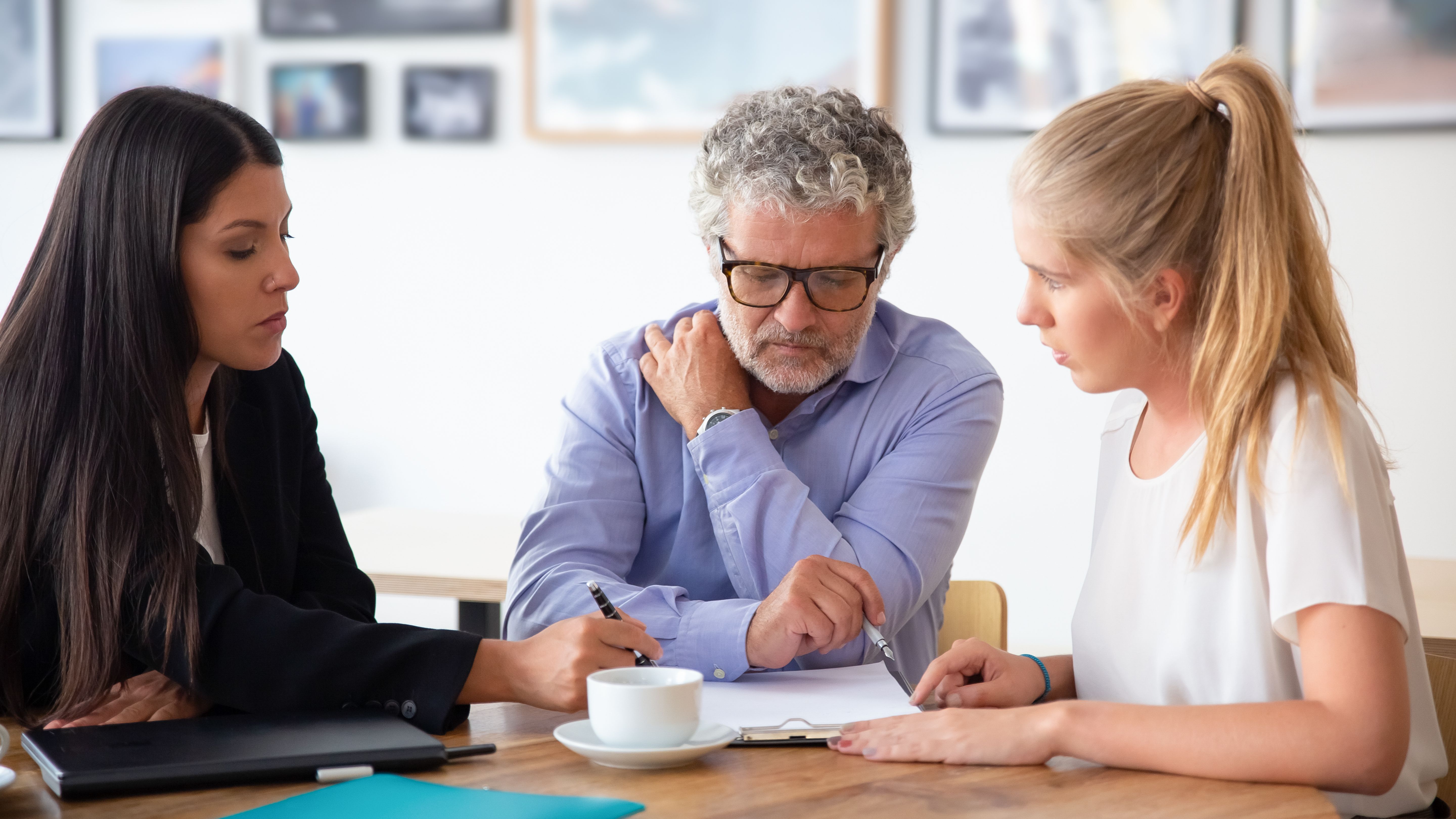 Father and adult daughter working with a tax adviser.