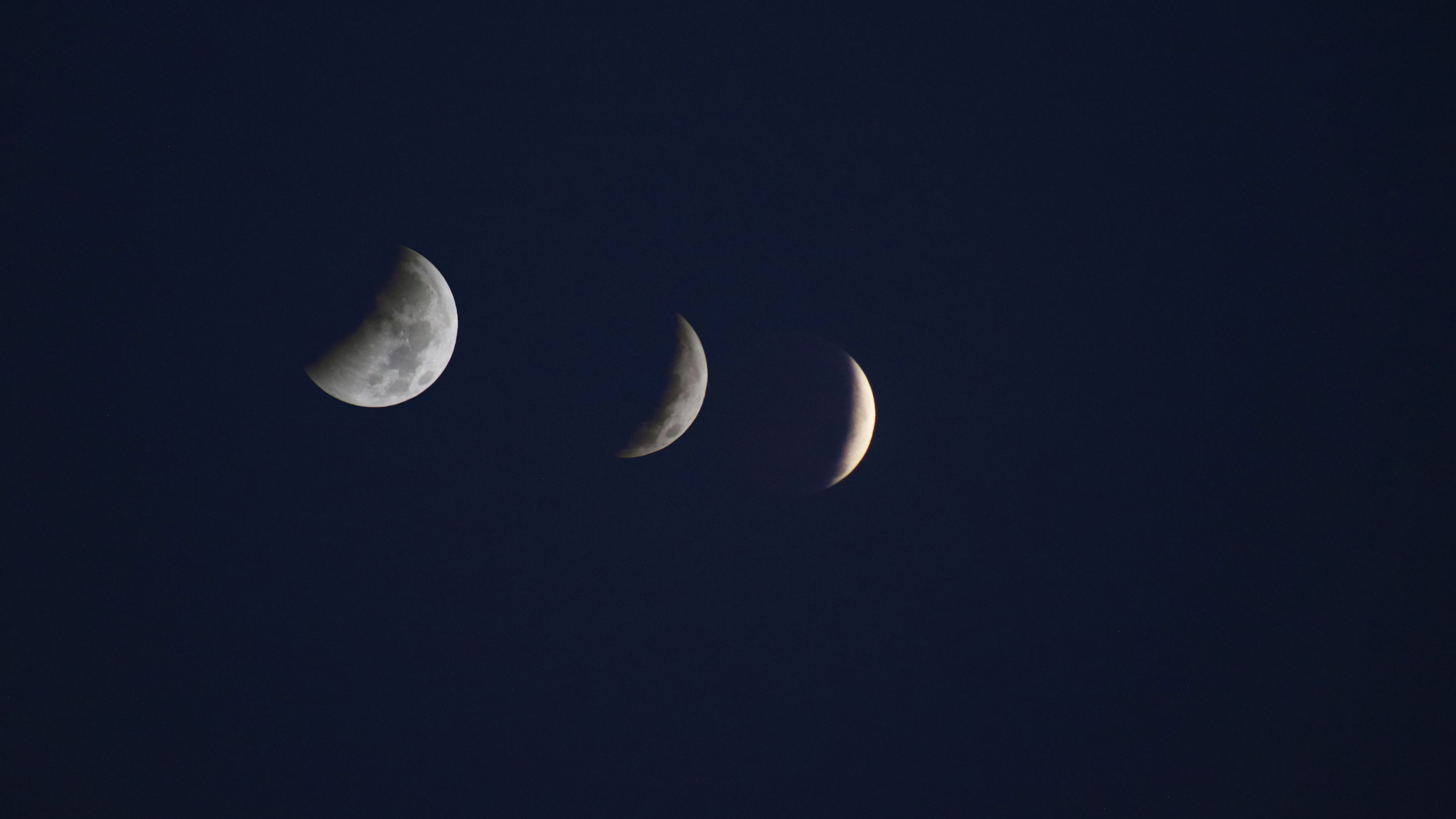 composite image showing stages of the partial lunar eclipse as the moon is covered by more and more of Earth's deep dark umbral shadow.