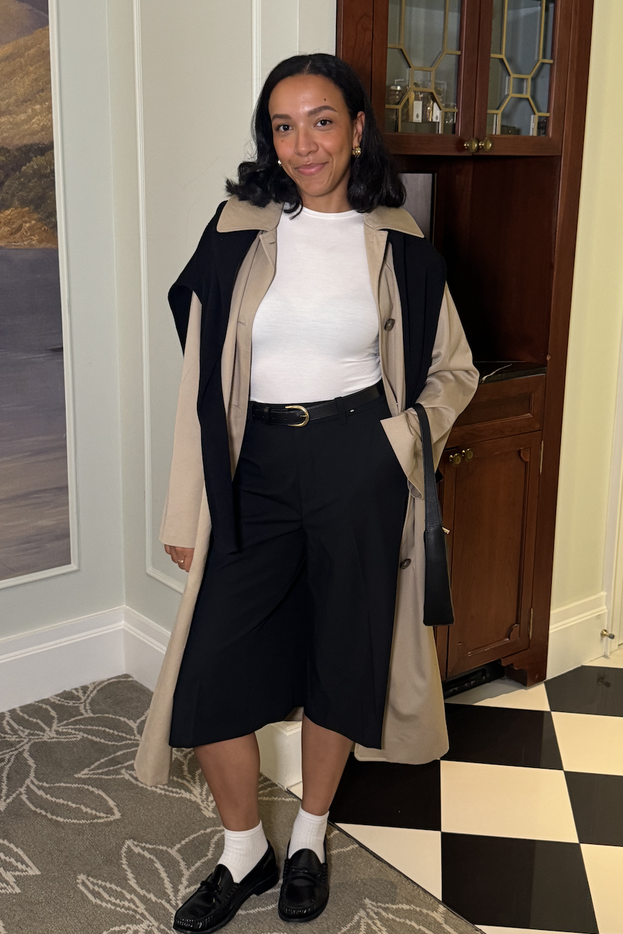 Lauren Tappan wearing a white tee, culottes, a trench coat, and loafers
