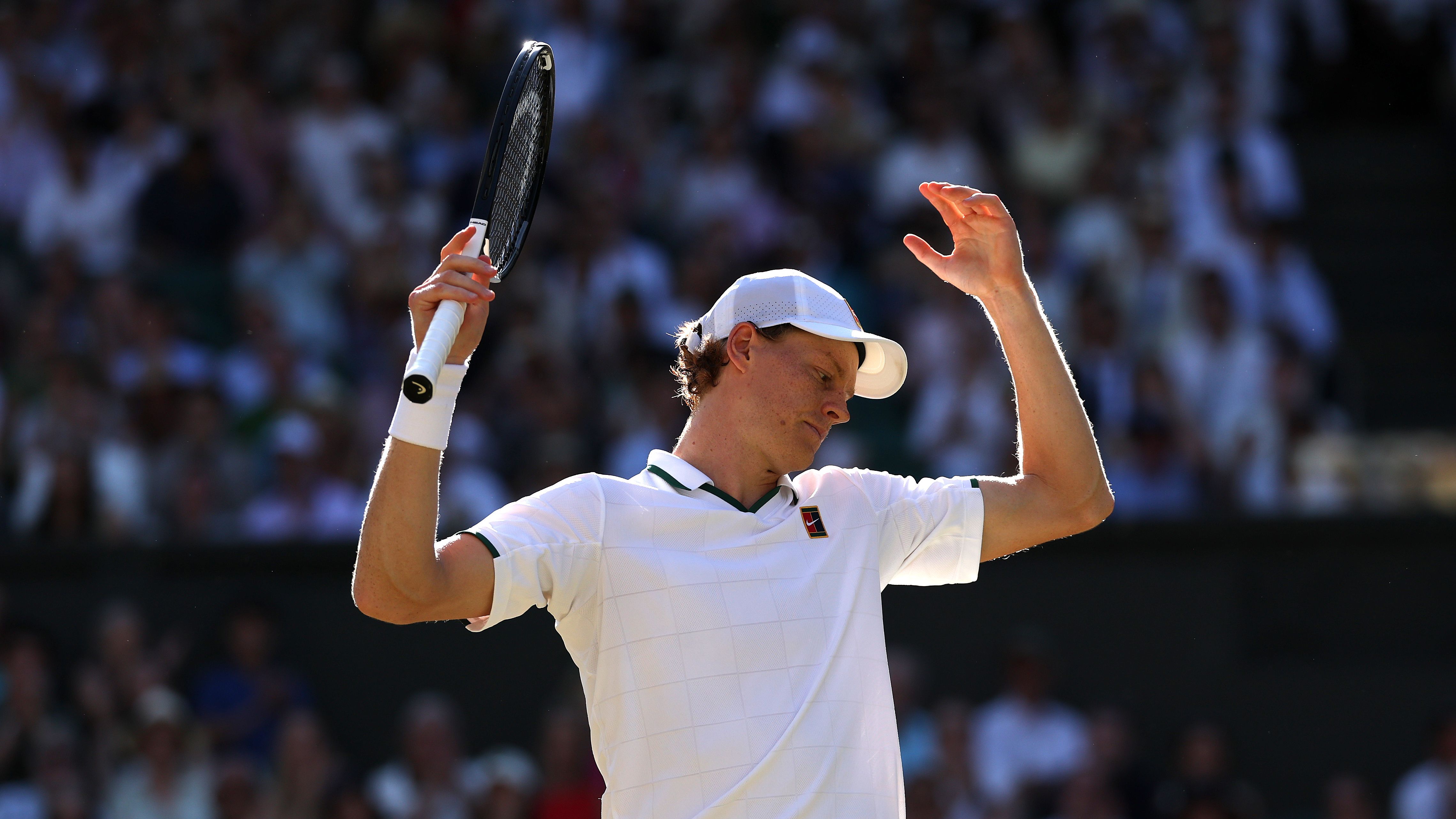 Jannik Sinner with racquet raised