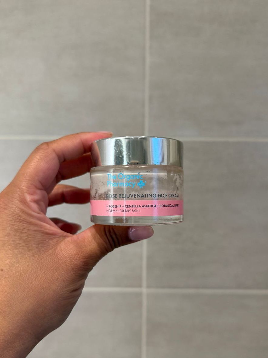 Aleesha holding empty The Organic Pharmacy Rose Rejuvenating Cream