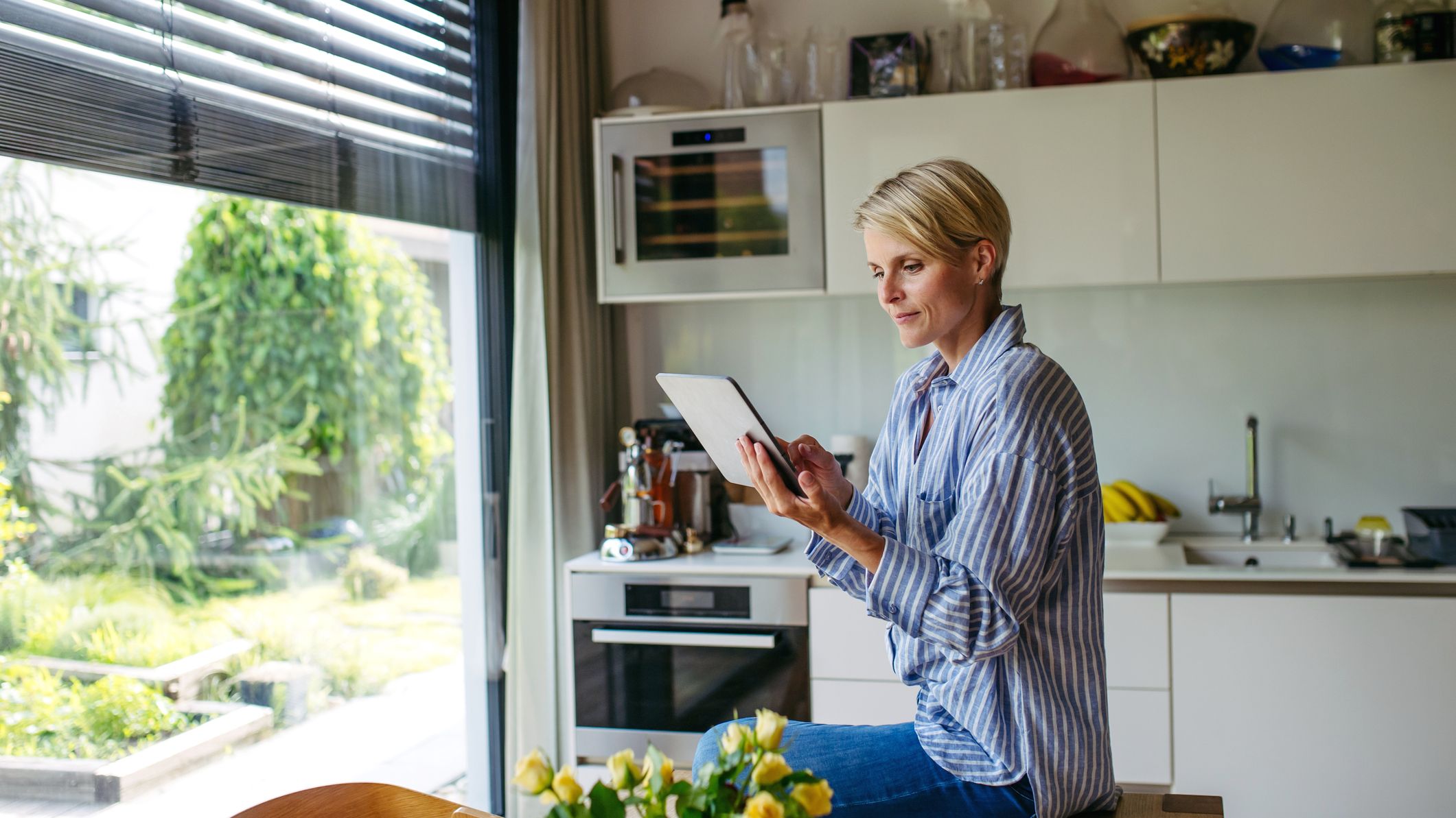 a woman sets temperature control on her tablet