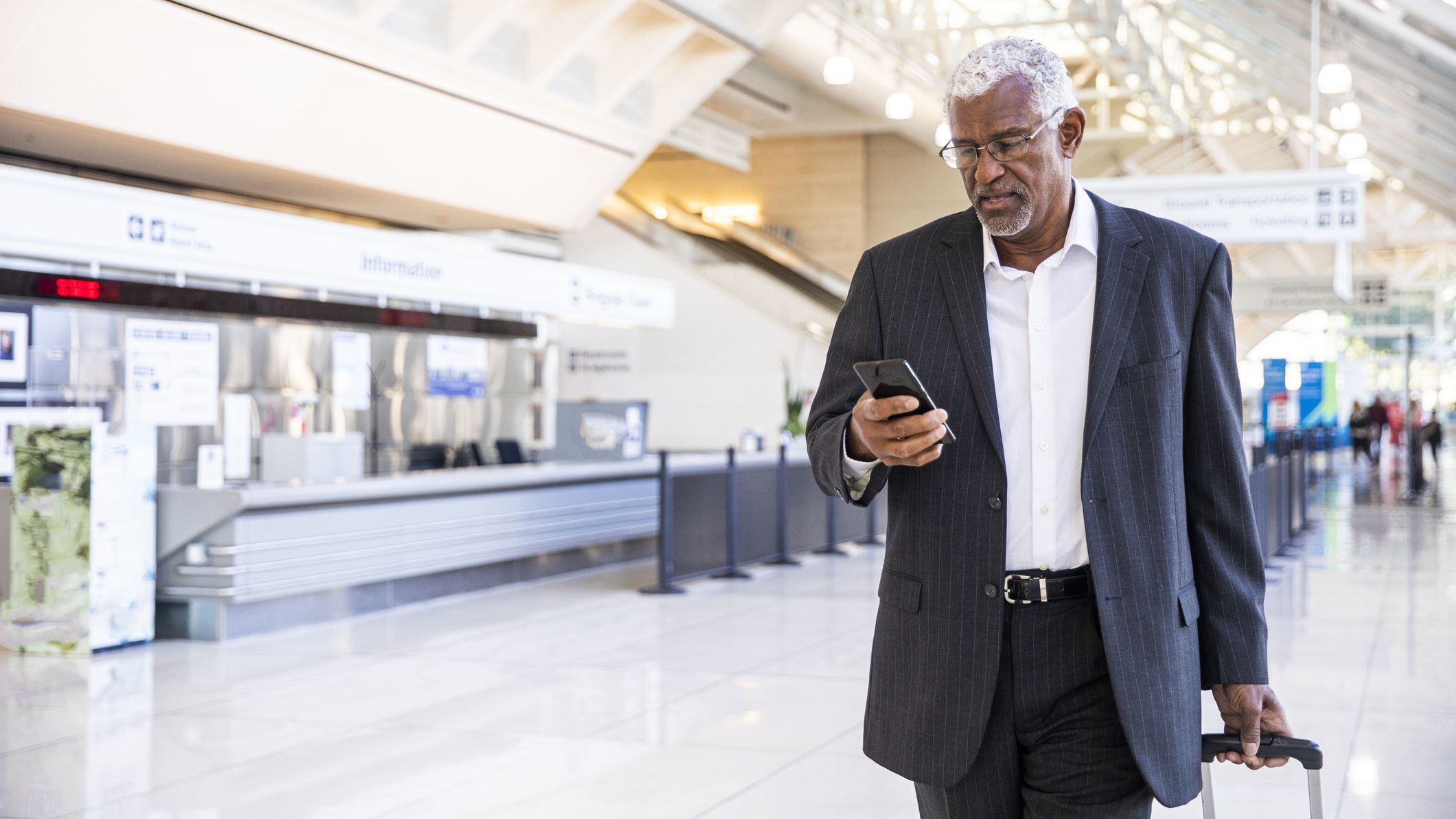 A man using his phone in the airport