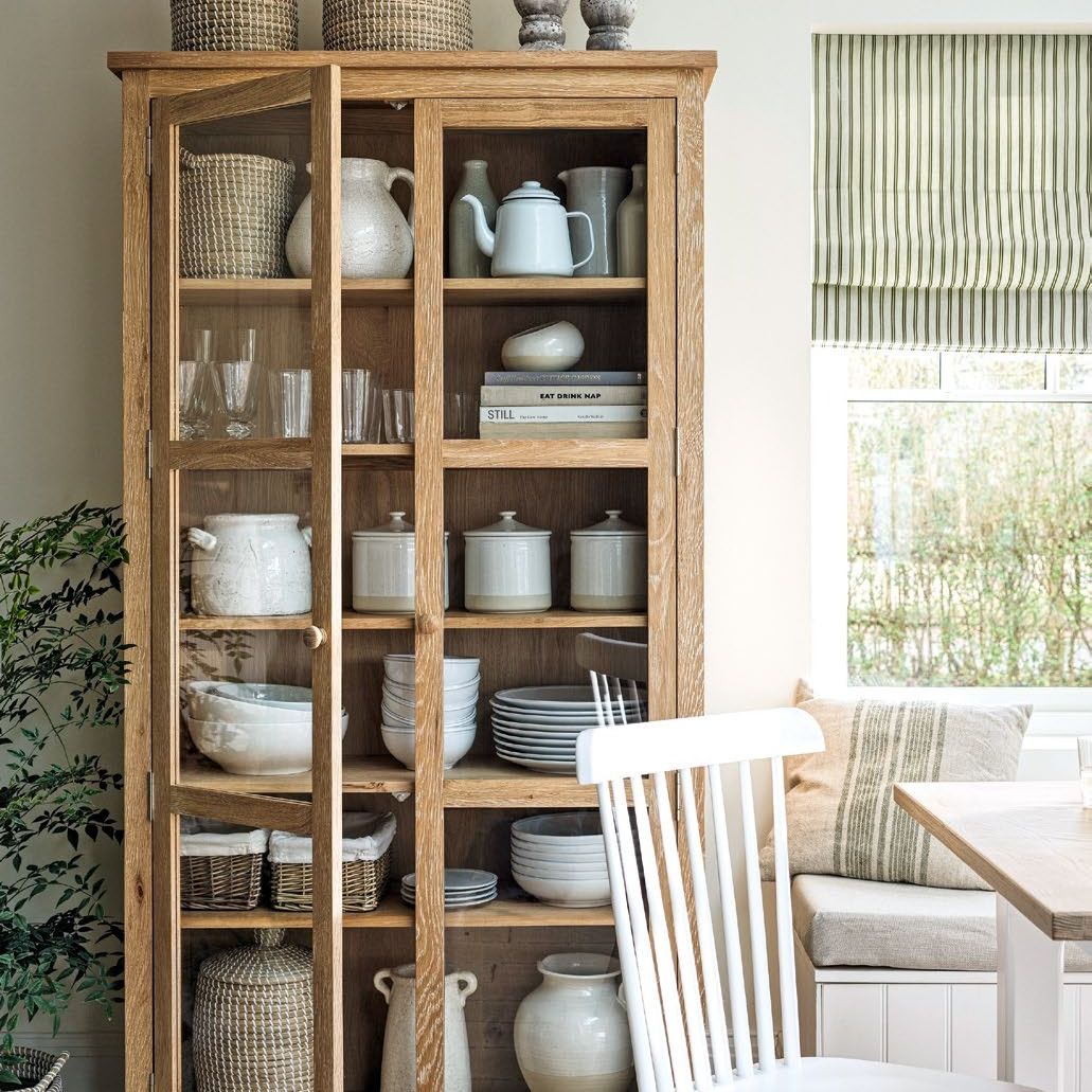 White kitchen with wooden shelving unit and white chair