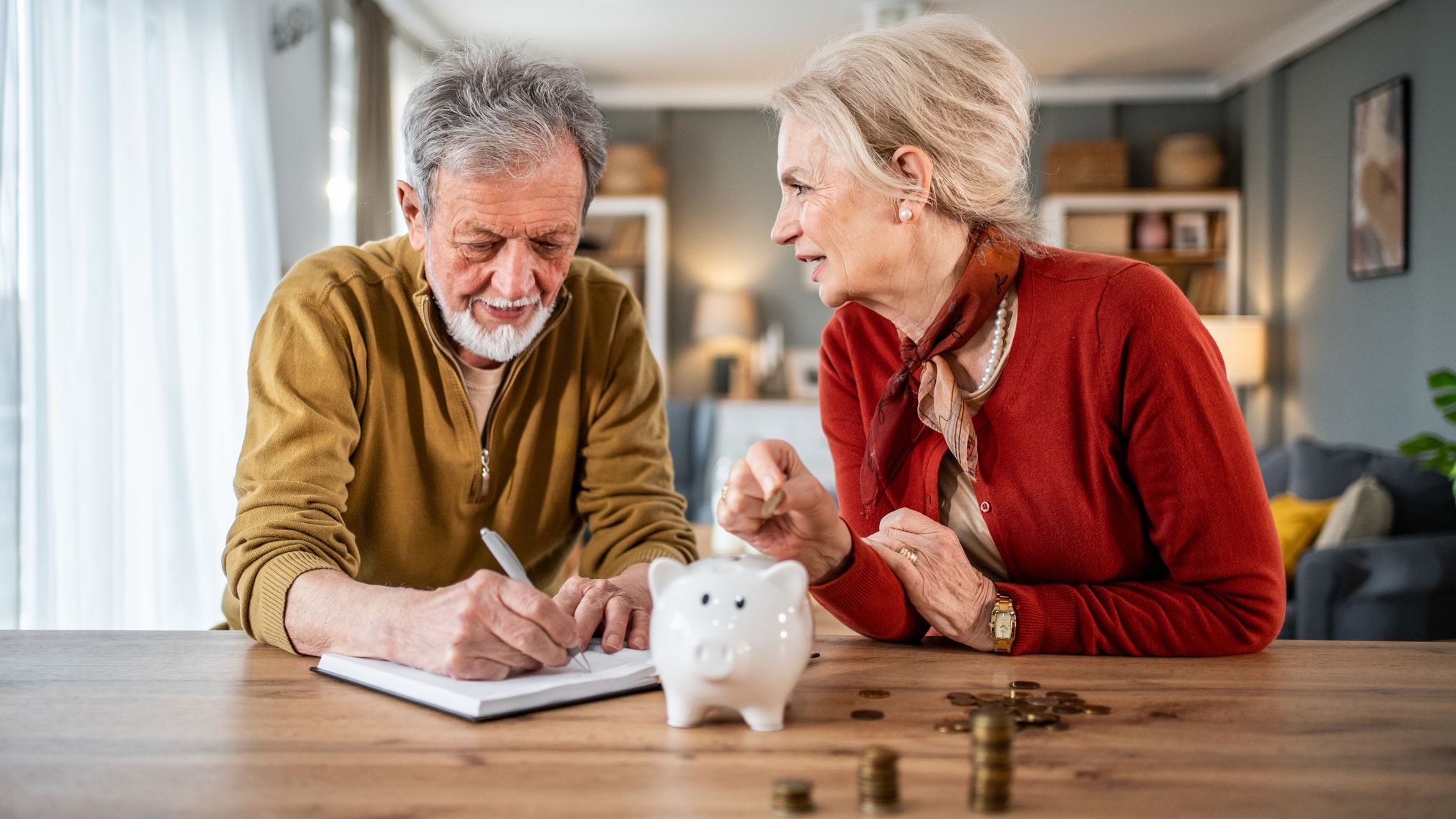 a couple discussing money goals at their kitchen table