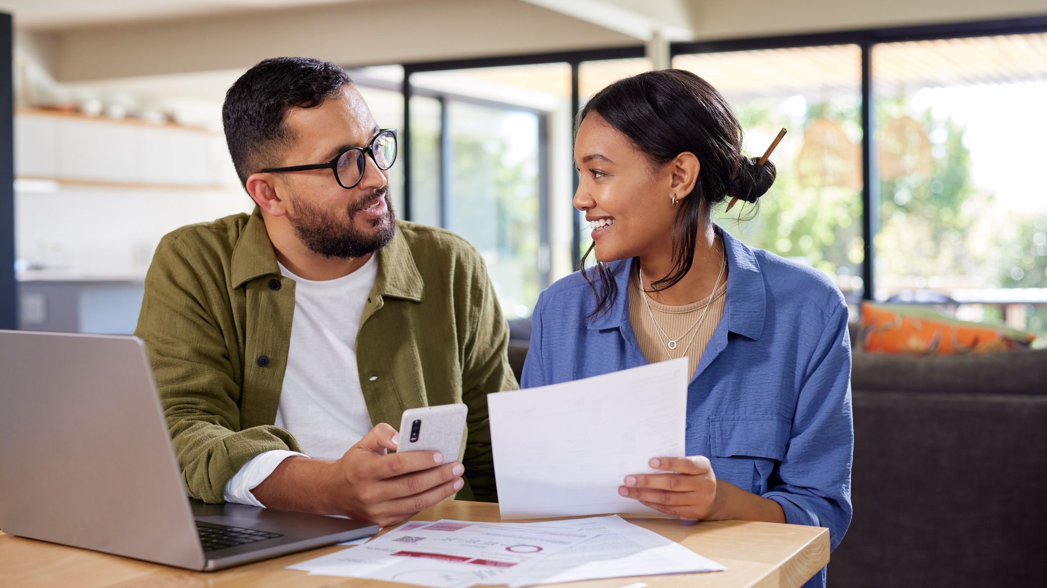 a couple discussing a financial decision at a table
