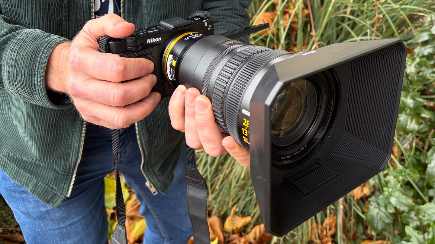 Person holding a Nikon ZR with Z 28-135mm f/4 PZ lens
