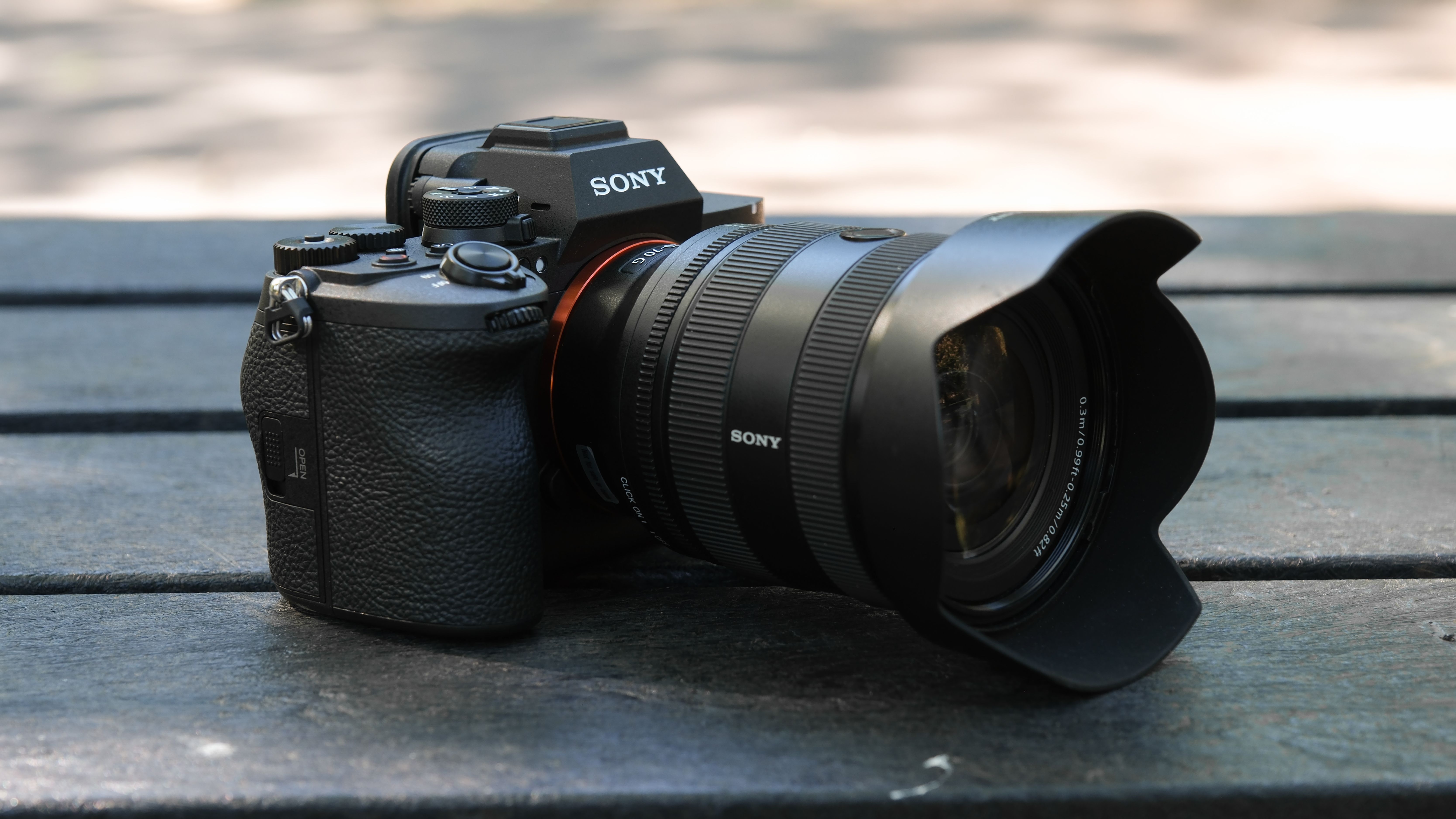 Sony A7R VI fitted with a Sony zoom lens on a wooden bench.