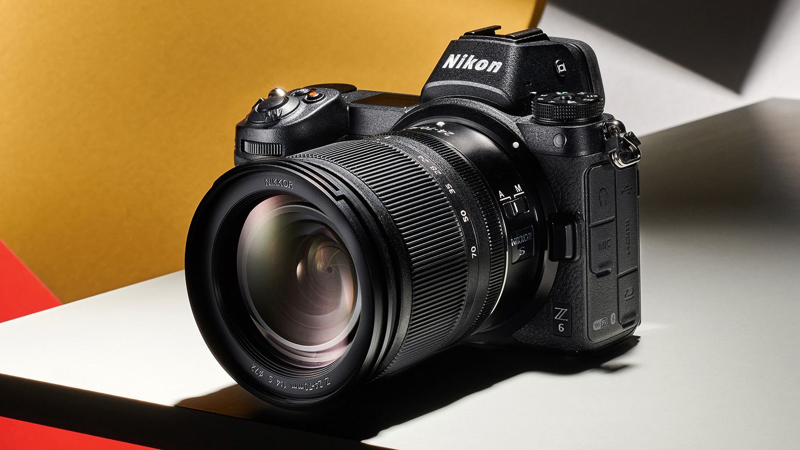 Nikon Z6 product image on a yellow, red, and grey background