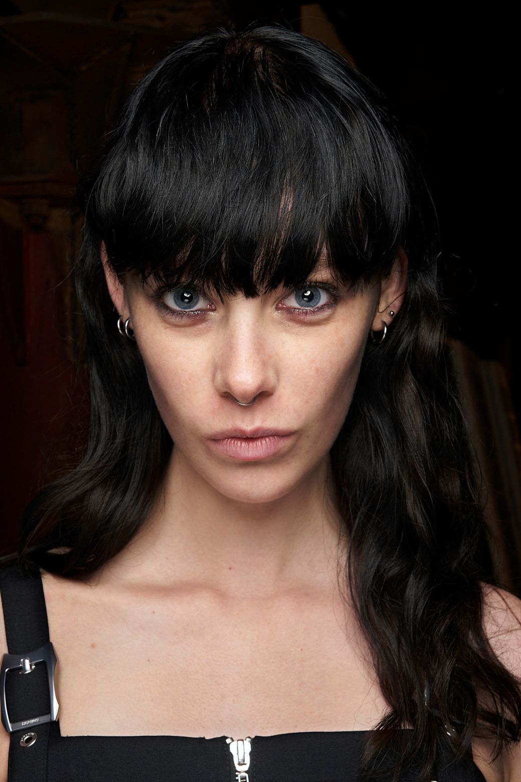 blown out bangs on a model in all black wiht black hair