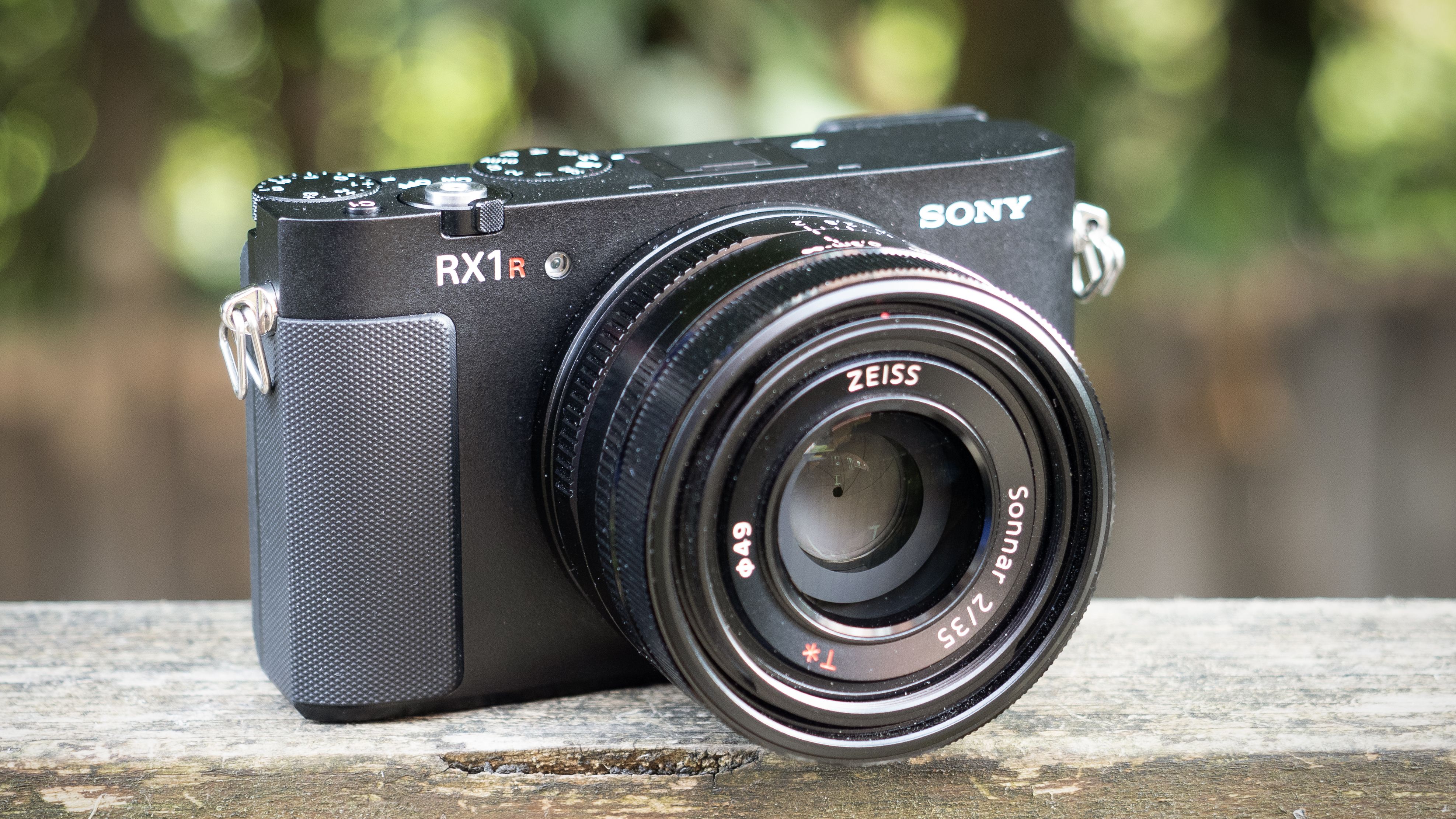 Sony RX1R III on a wooden surface in a woodland environment