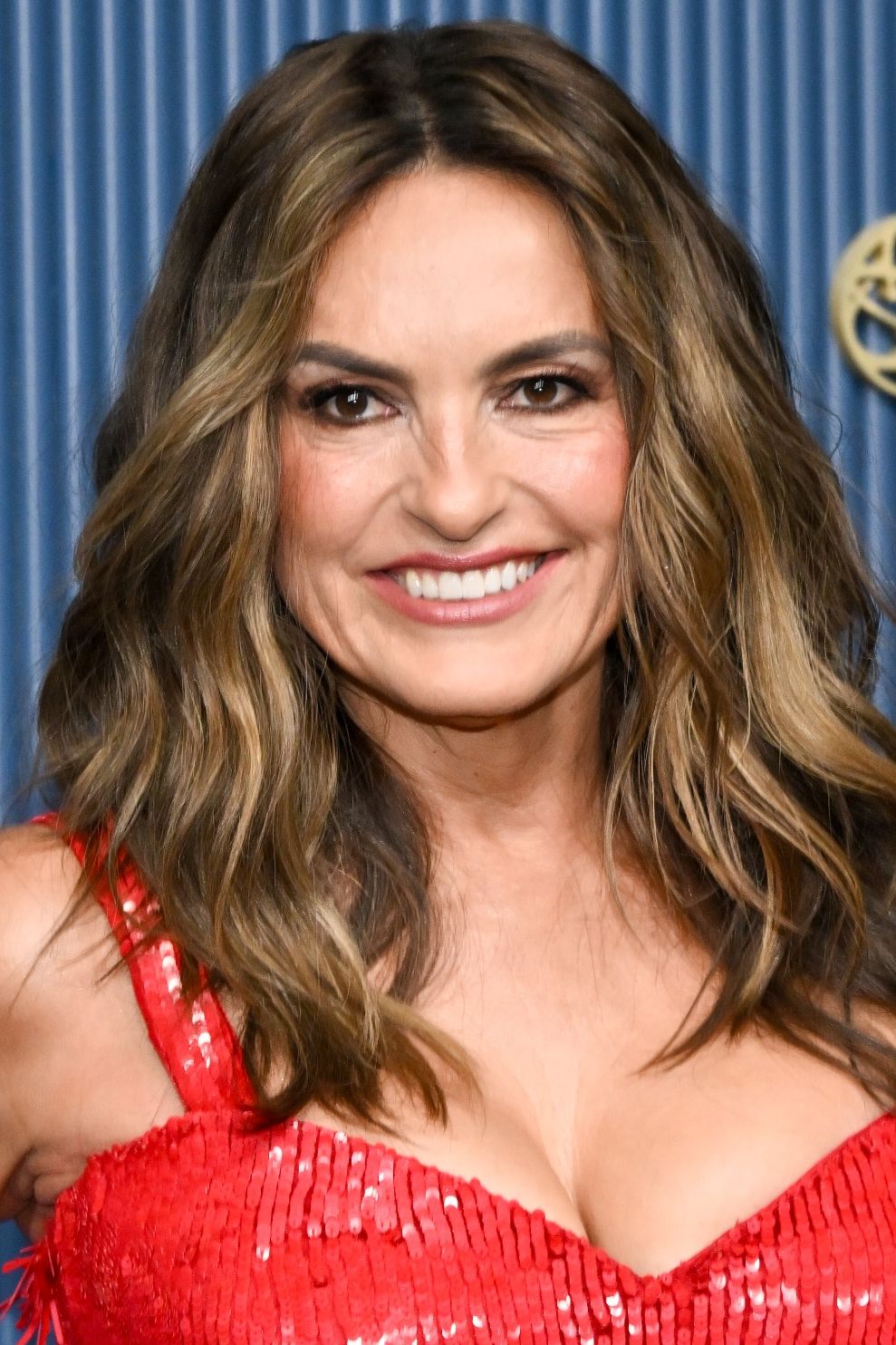 mariska hargitay in a red dress at the emmys step and repeat