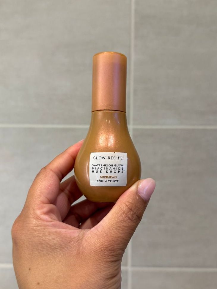 Aleesha holding empty Glow Recipe Niacinamide Hue Drops