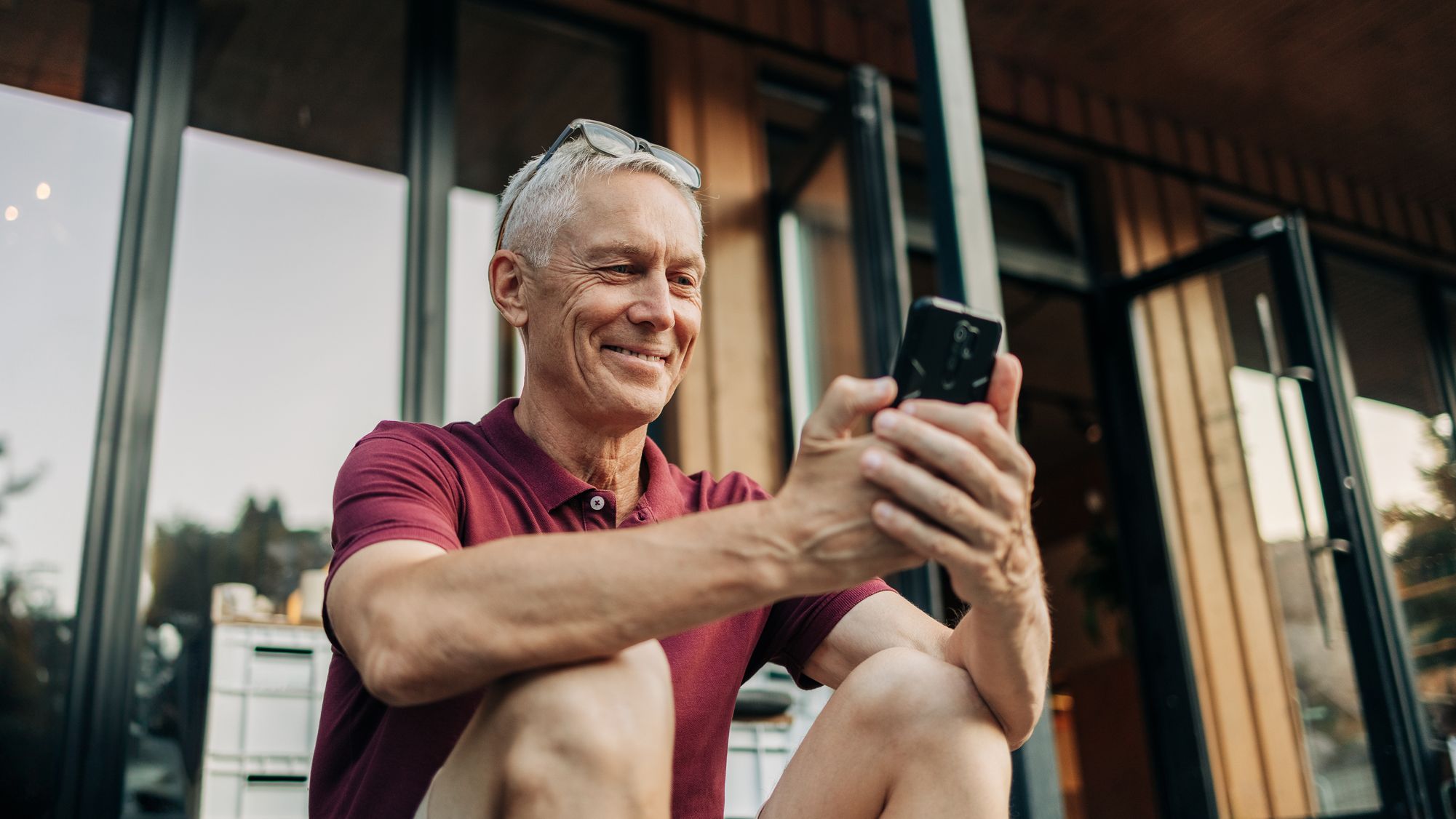 An older man checks his AI retirement plan on his phone