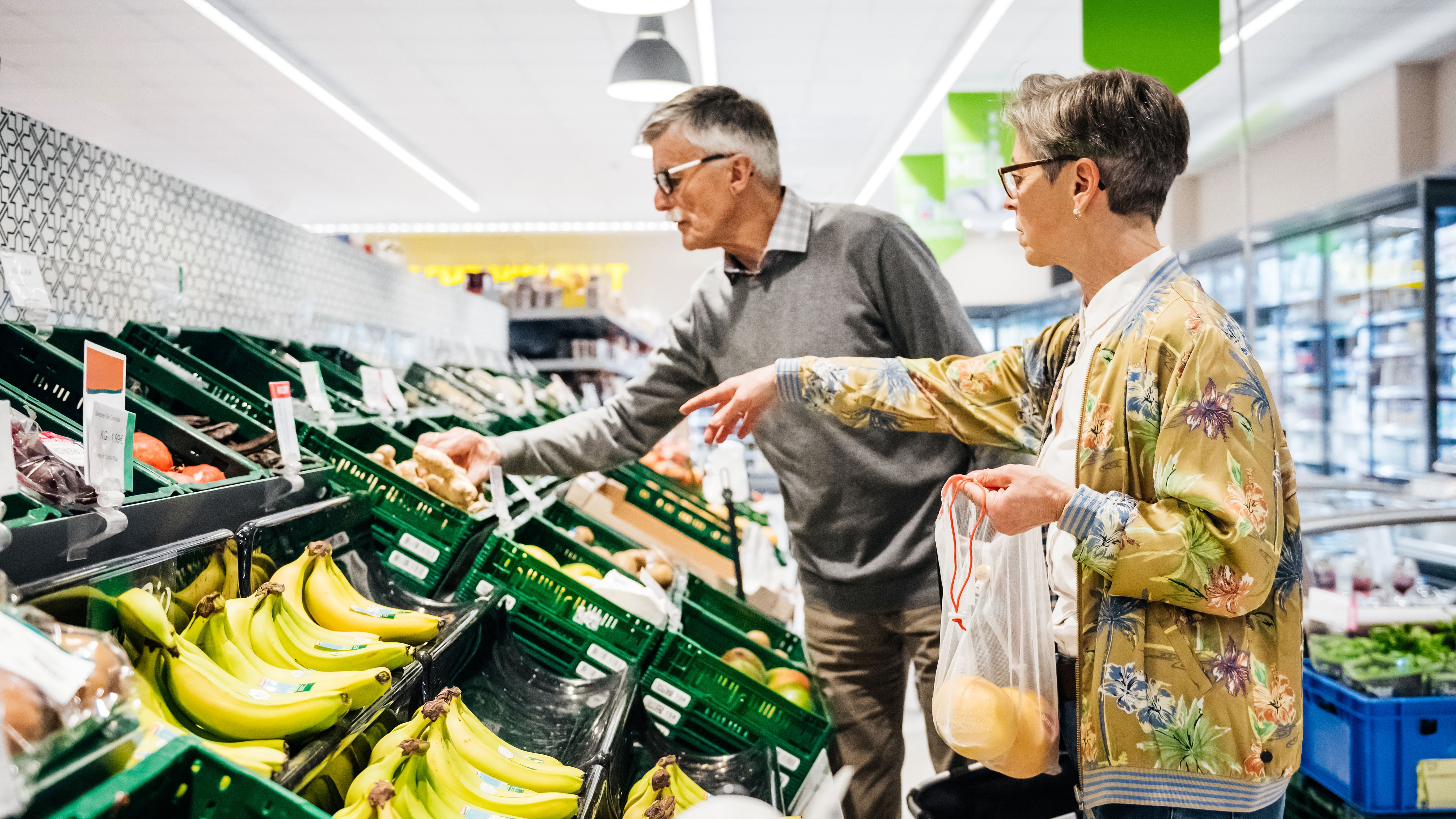 Senior Couple Buying Fruit And Vegetables Together