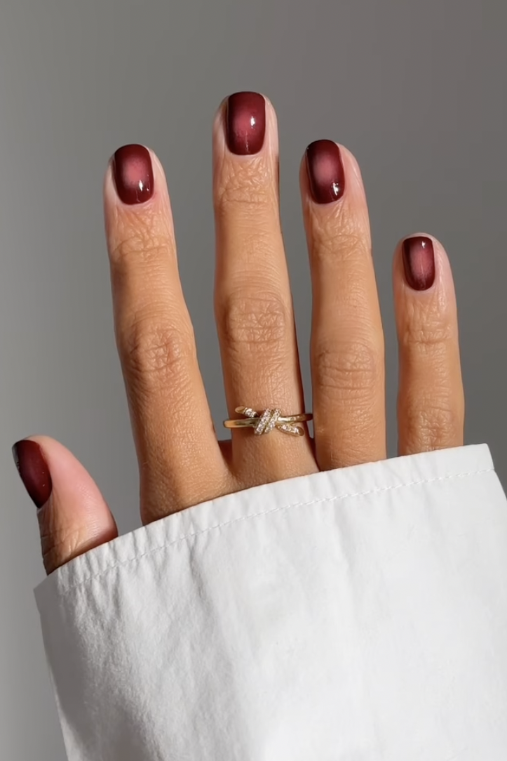 deep burgundy cat-eye manicure on short square nails