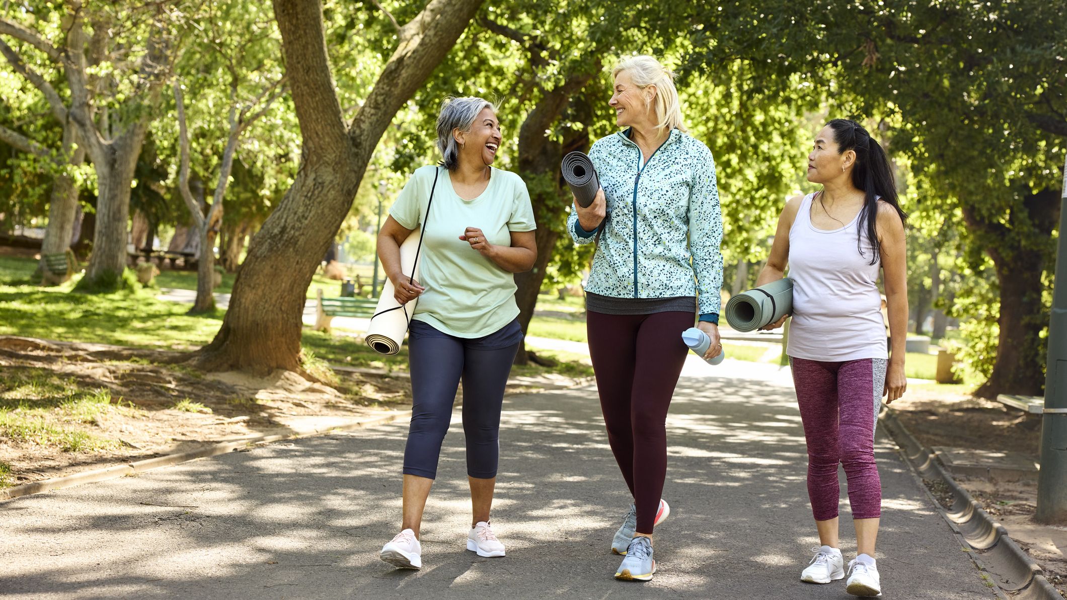 three women walking on a trail
