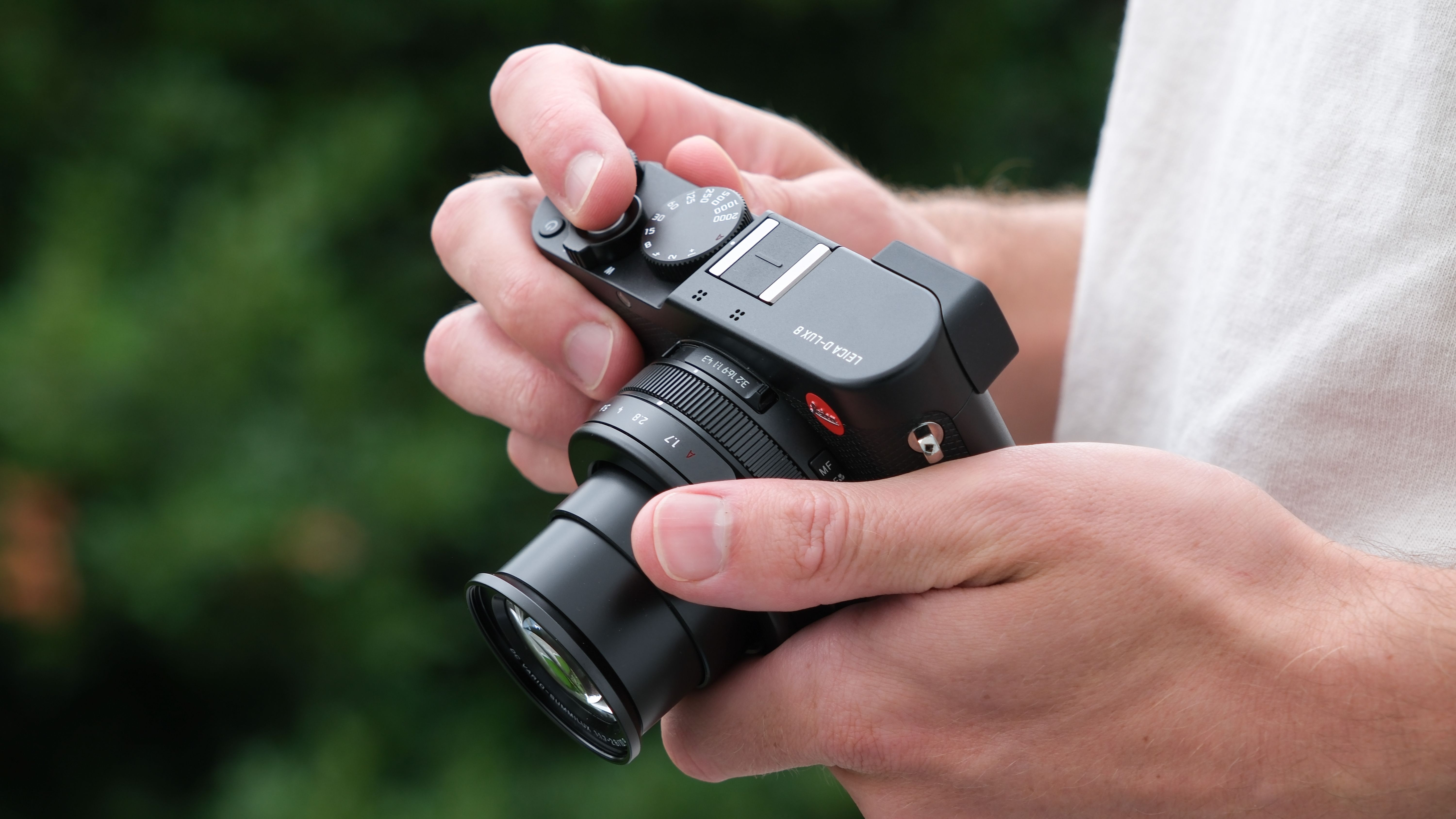 Leica D-Lux 8 camera held in a pair of hands