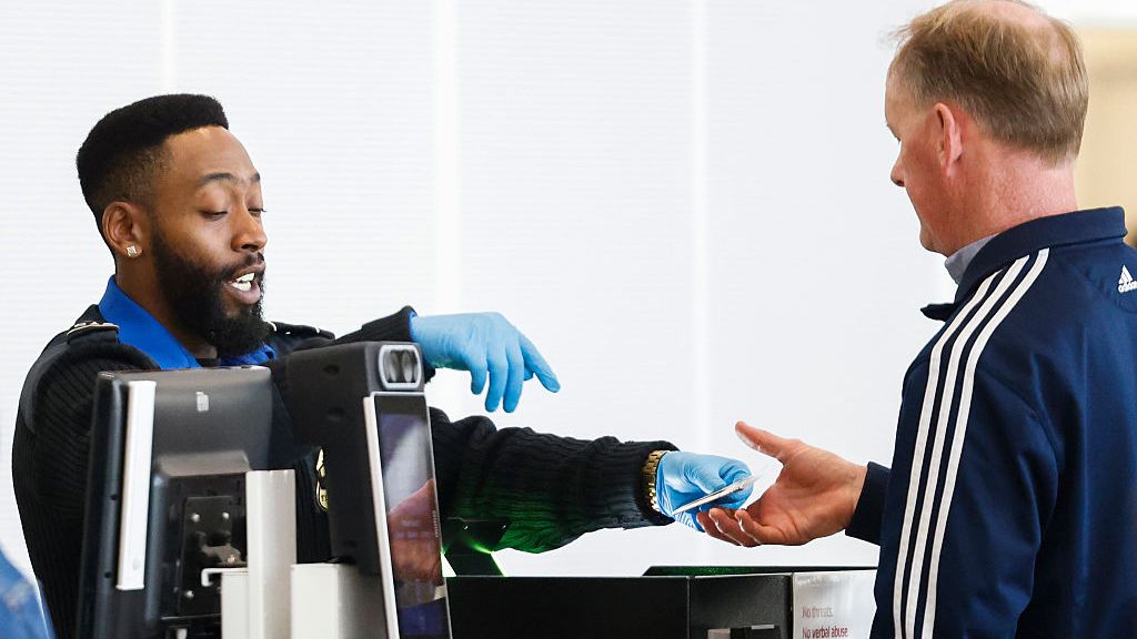 TSA agent returning a traveler's ID