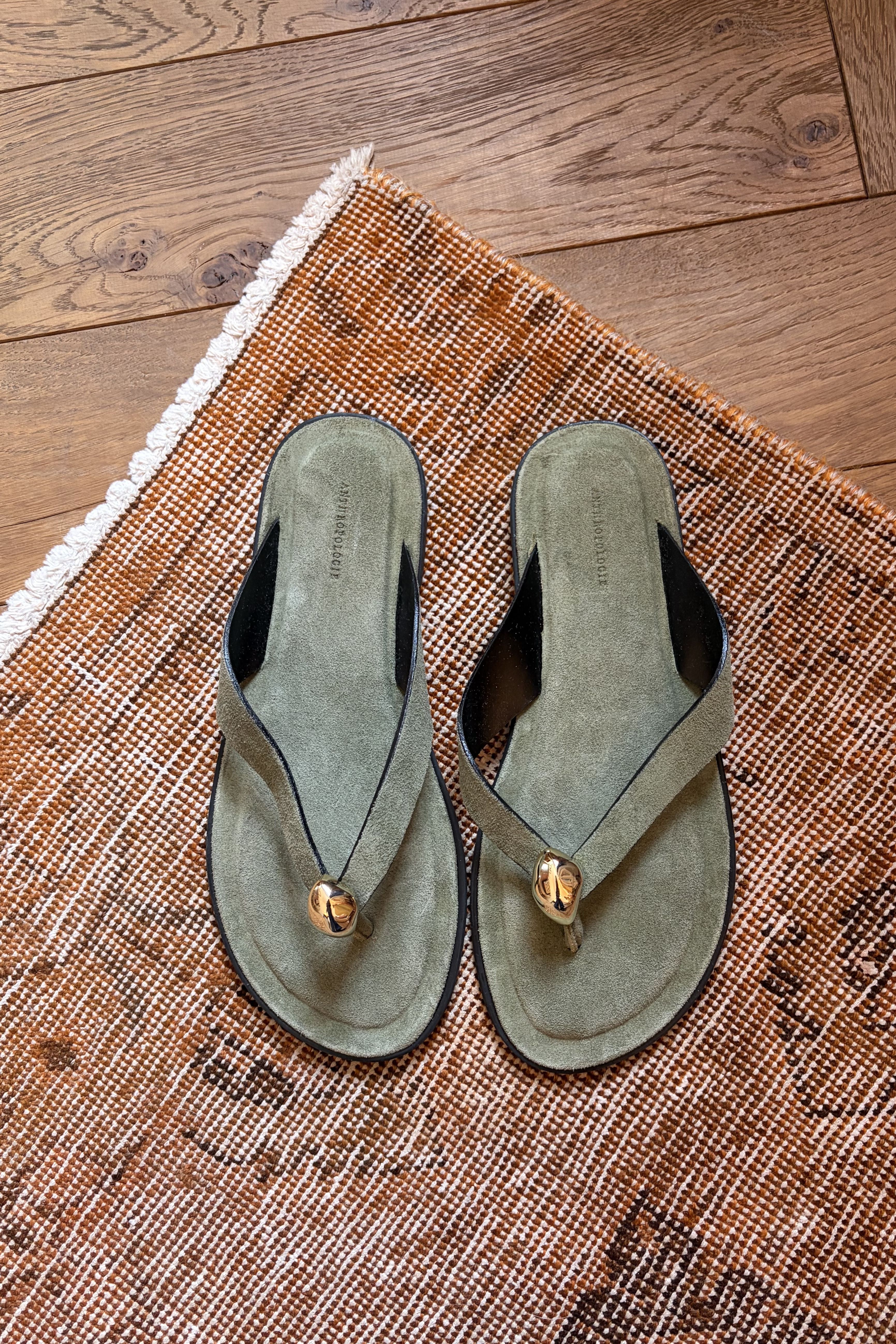 Green suede sandals with gold hardware
