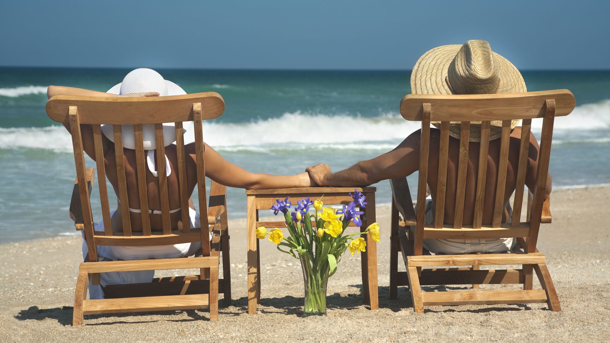 vacation couple relaxing in teak chairs enjoying perfect day in Florida