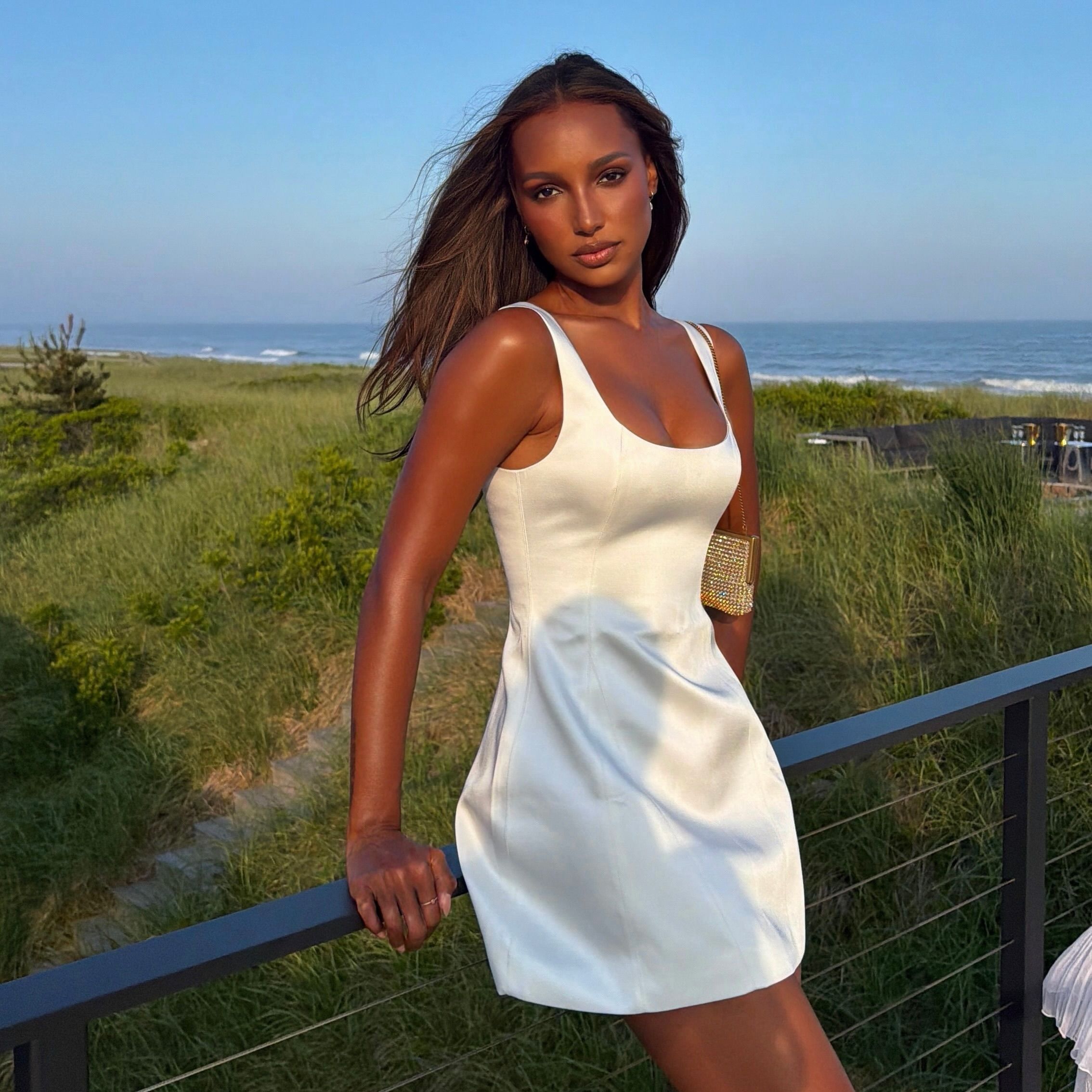Photo of Jasmine Tookes wearing a white dress in the Hamptons