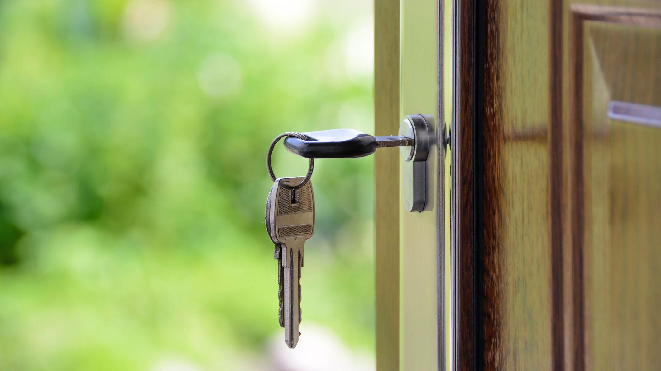 Close-up on a house key hanging on a door