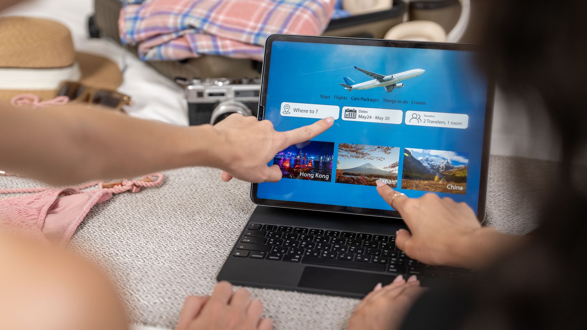 A couple planning a vacation on a laptop.
