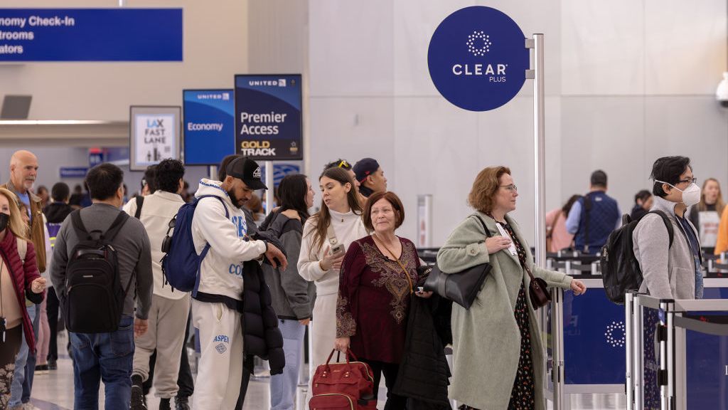 Passengers stand in Clear Plus line that gets them to their gate faster, using their eyes or fingerprints to verification, at Los Angeles International Airport.