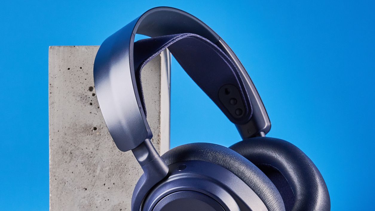 The SteelSeries Arctis Nova Pro Omni on a stone surface against a blue background