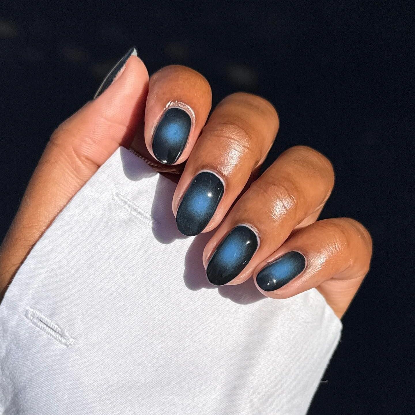 blue manicure with aura design