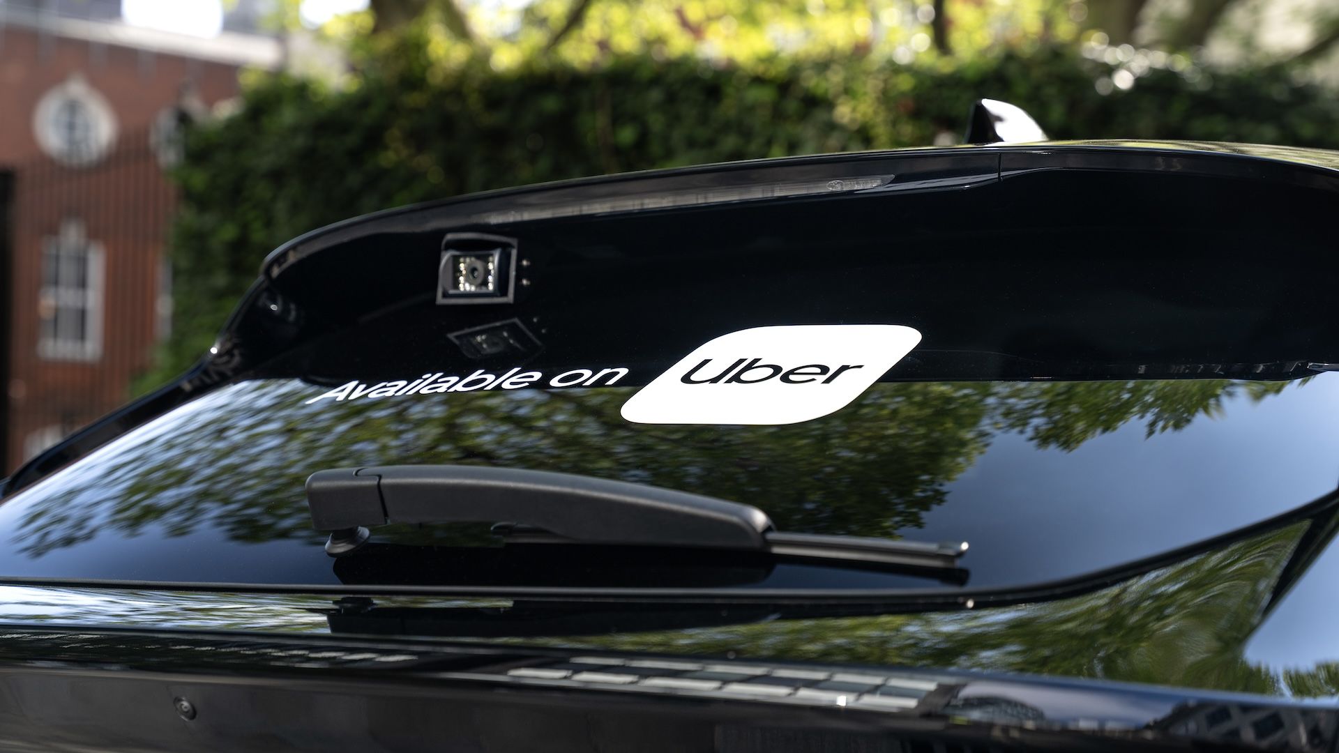 The back window of a car with the words "Available on Uber"