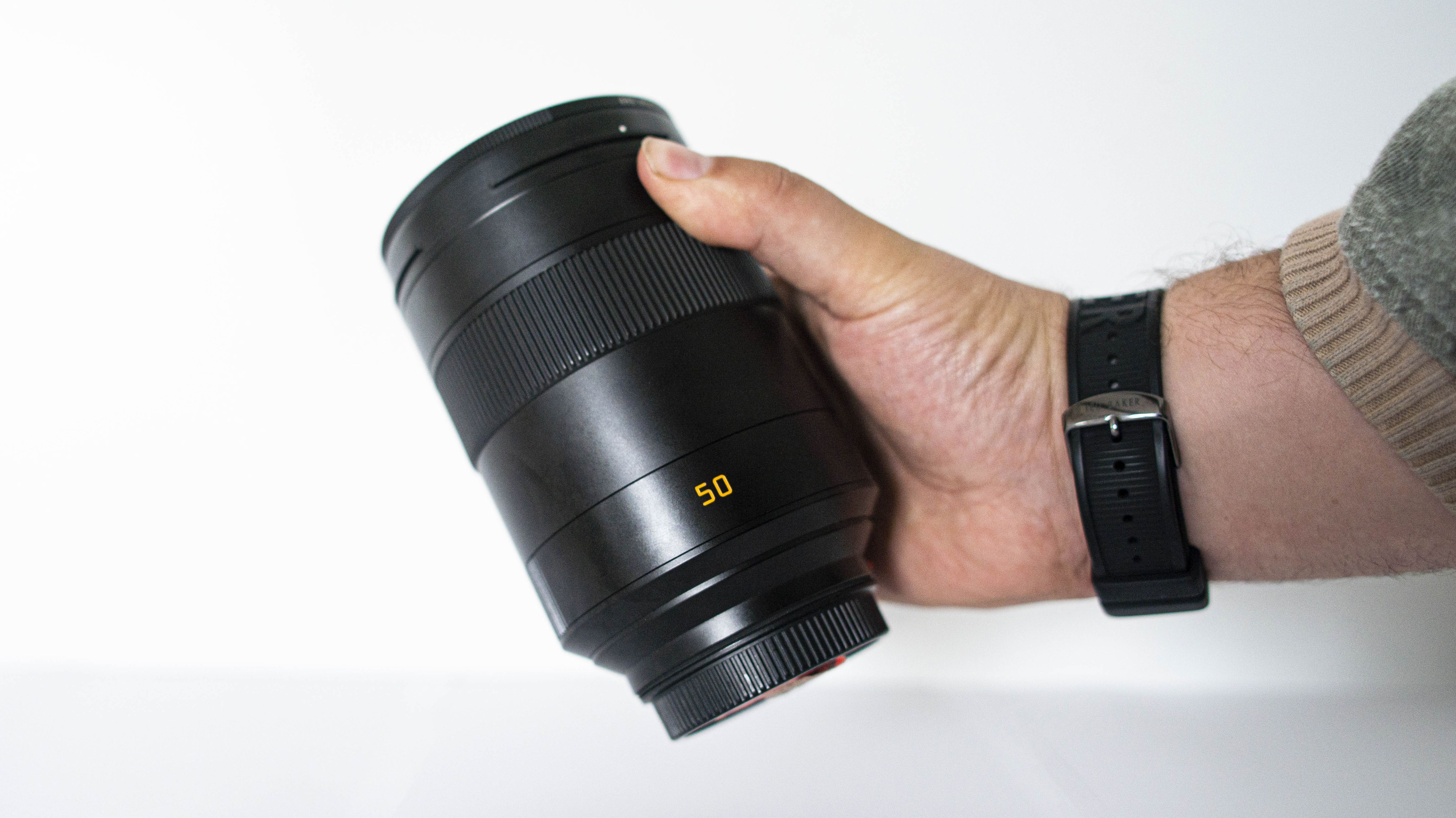 Leica 50mm Summilux-SL f/1.4 ASPH held in the hand, showcasing the size of the Leica