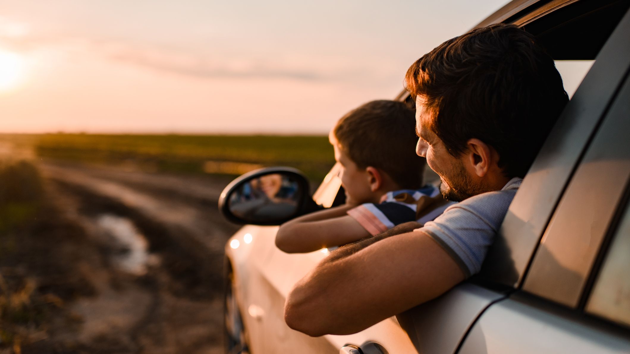 Beautiful father and son enjoying on a road trip