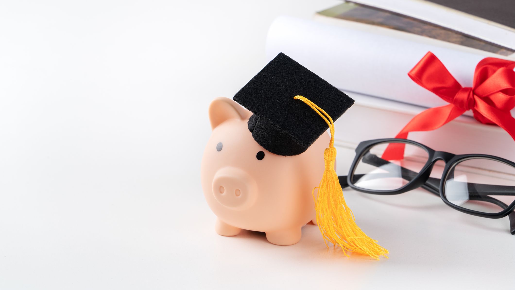 A piggy bank wearing a graduation cap.