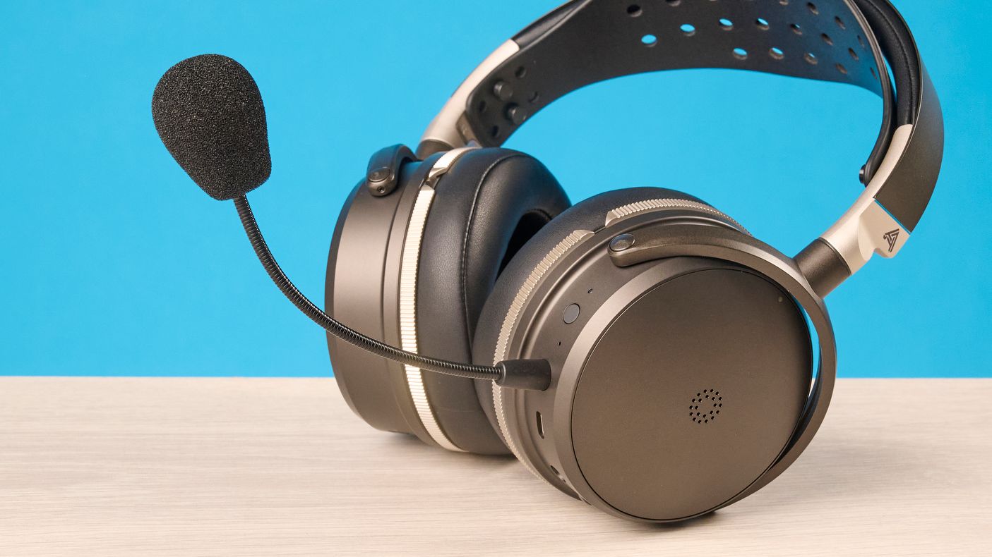 The Audeze Maxwell 2 ANC on a wooden desk with a blue background